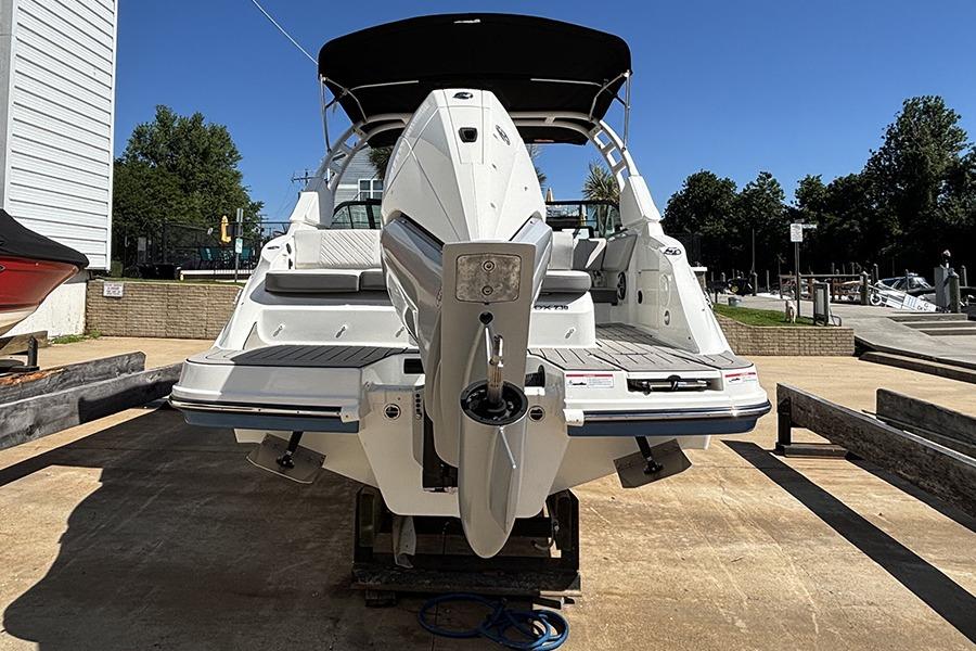 2027 Sea Ray SDX 230 Outboard boat on display at a marina.