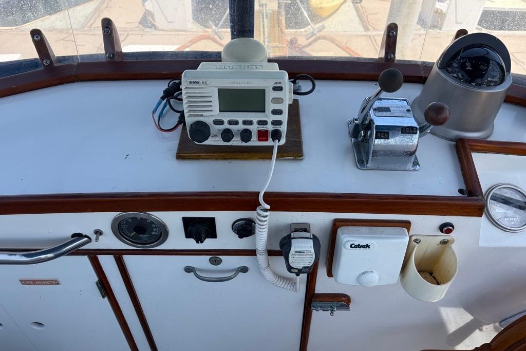 Control panel of a 1976 Grand Banks 32 Sedan boat with radio and navigation instruments.