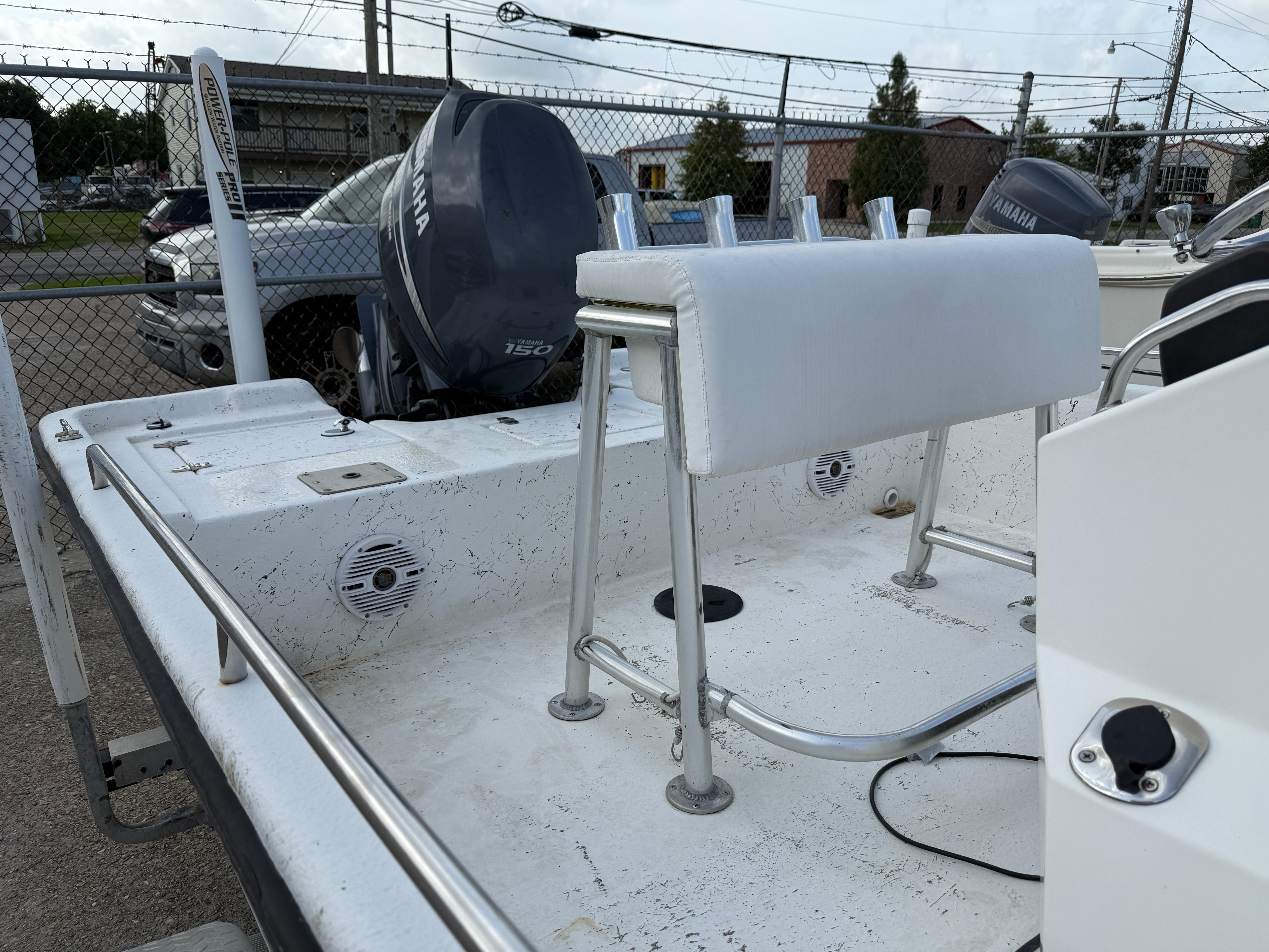 2010 Blazer Bay 2170 boat with Yamaha outboard motor, docked in a fenced area.