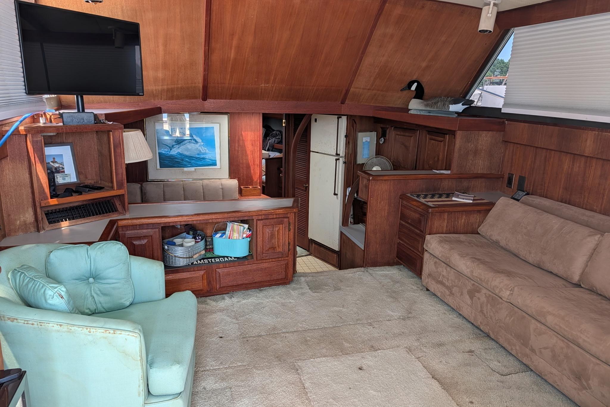 Interior of 1986 Viking Sportfish 41 yacht with cozy seating and wooden cabinetry.