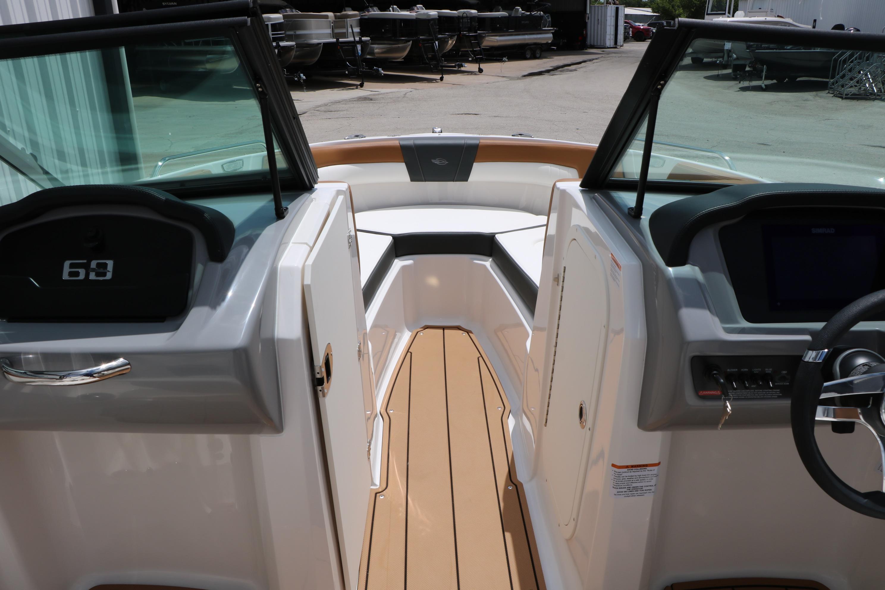 Interior view of 2025 Chaparral 23 SSi boat, featuring sleek dashboard and seating area.