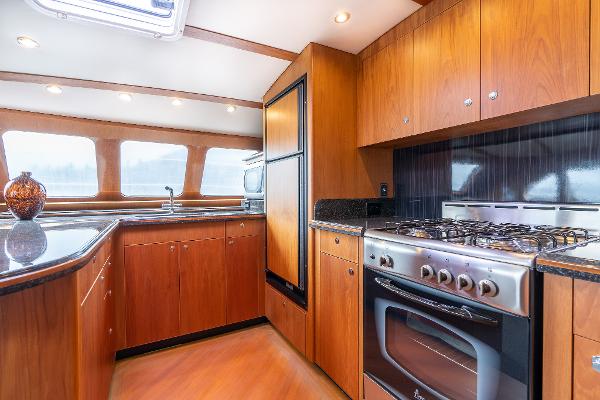 Luxurious kitchen interior of 2025 Shuttleworth 52 AeroRig yacht with modern appliances.