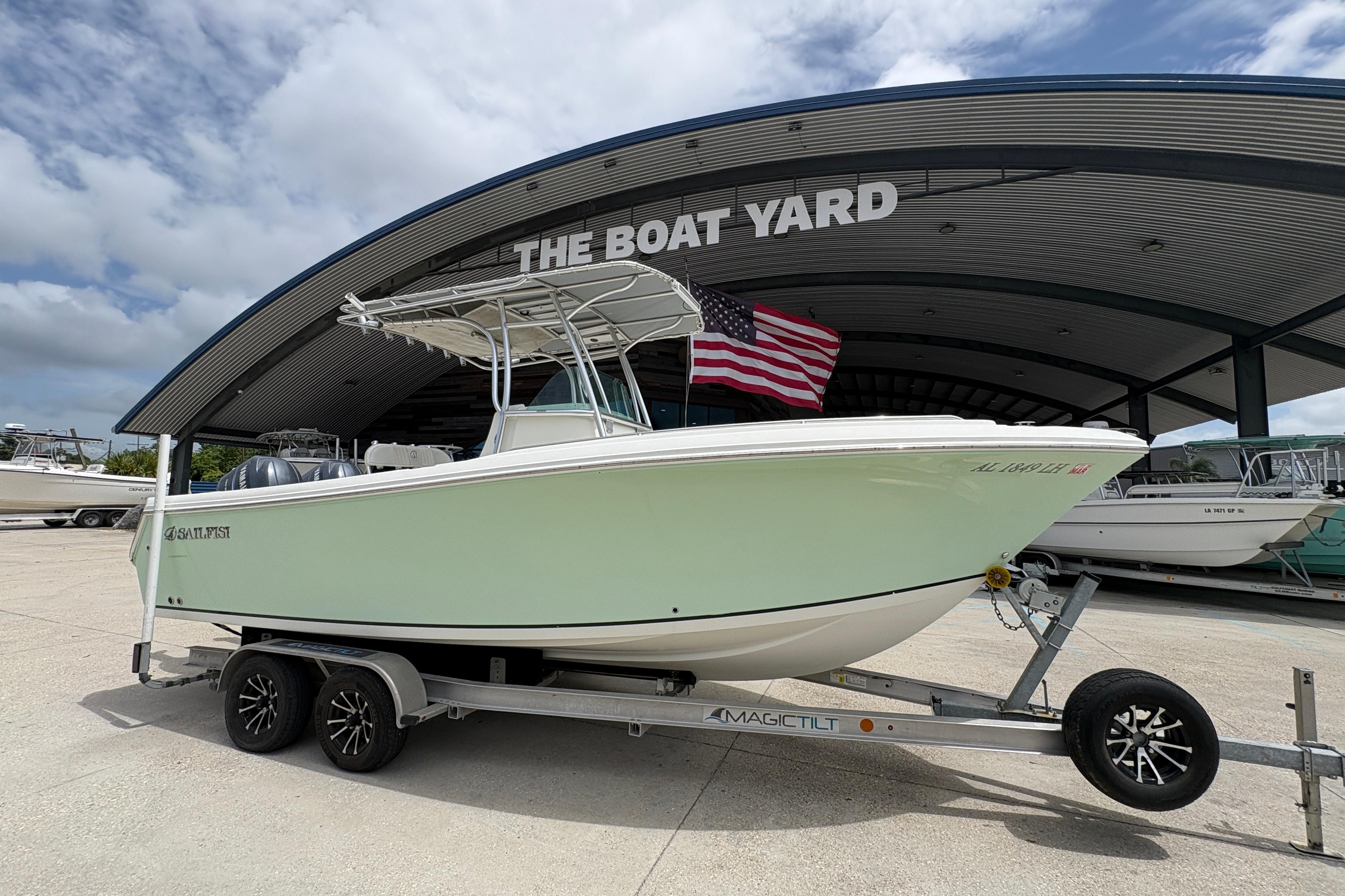 2006 Sail Faish 2360 boat on trailer at The Boat Yard, American flag displayed.