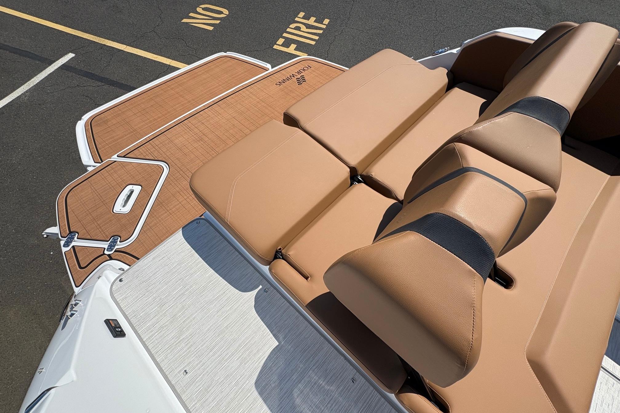 2026 Four Winns H6 boat with tan leather seating and teak-style deck.