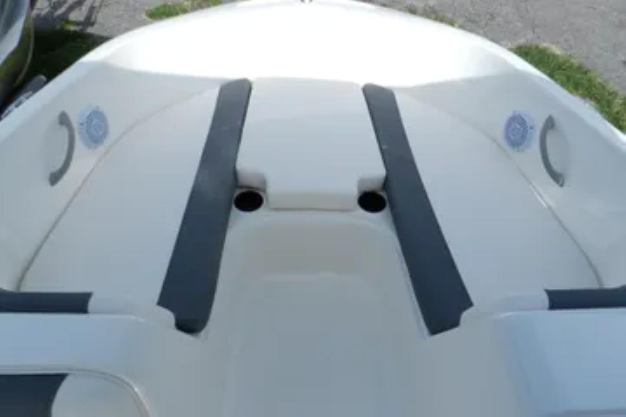 2026 Bayliner Element E18 boat interior with seating and cup holders.