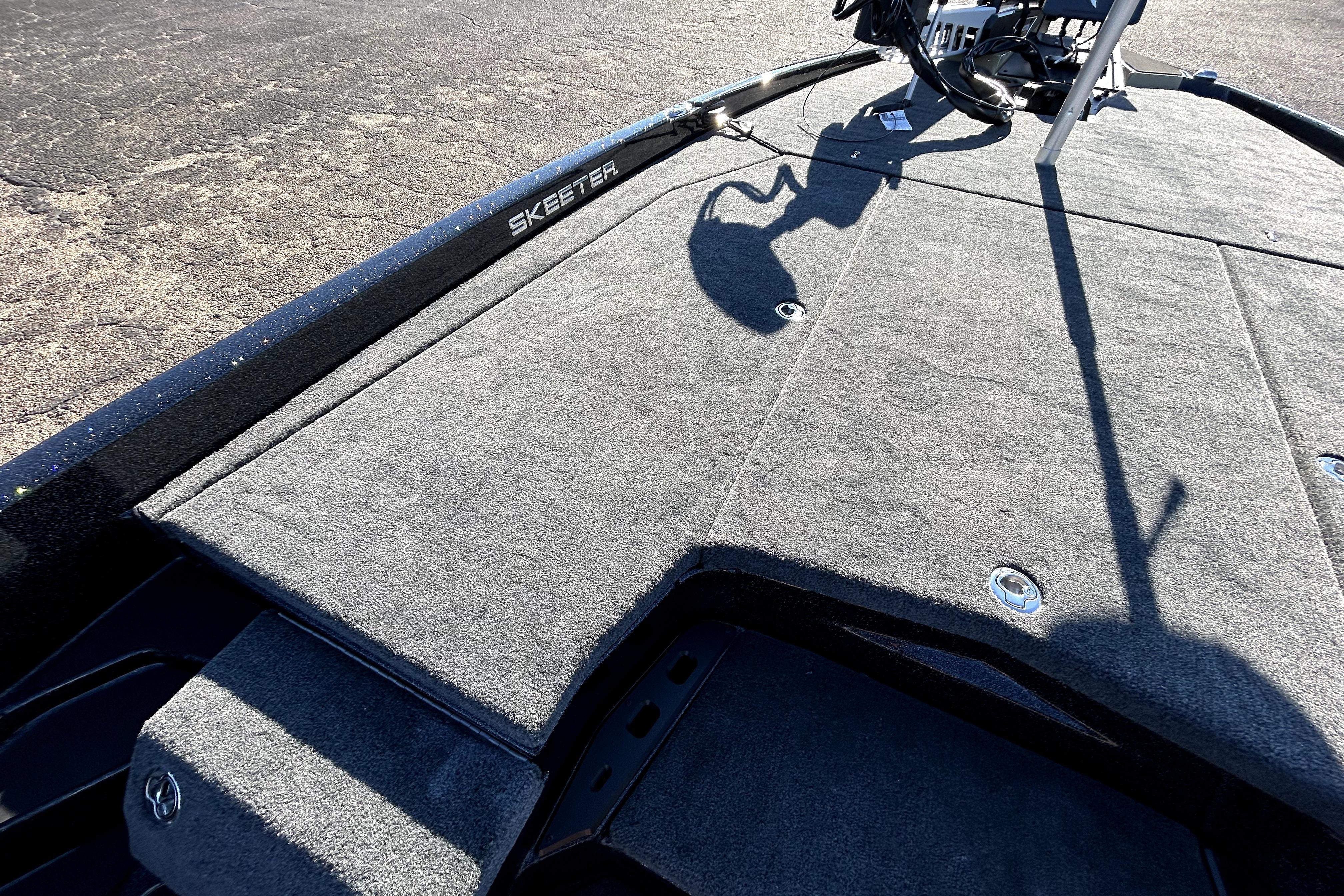 2026 Skeeter ZXE21 boat deck with carpeted surface and visible shadow.