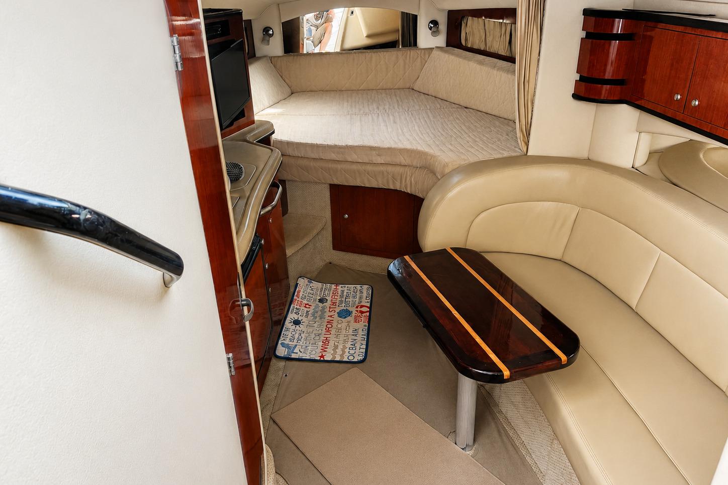 Interior of 2006 Sea Ray 300 Sundancer yacht with cozy seating and sleeping area.