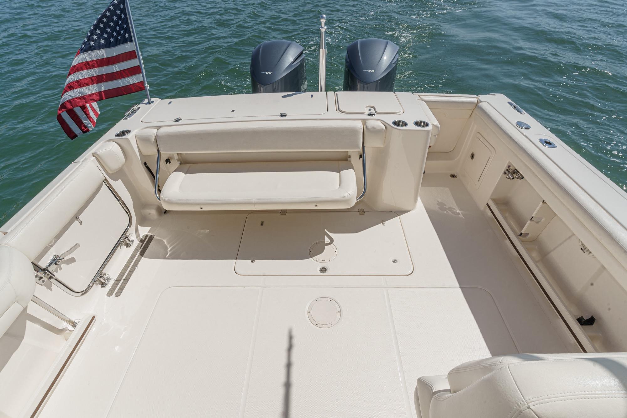 2016 Grady-White Freedom 335 boat deck with seating, American flag, and twin engines.