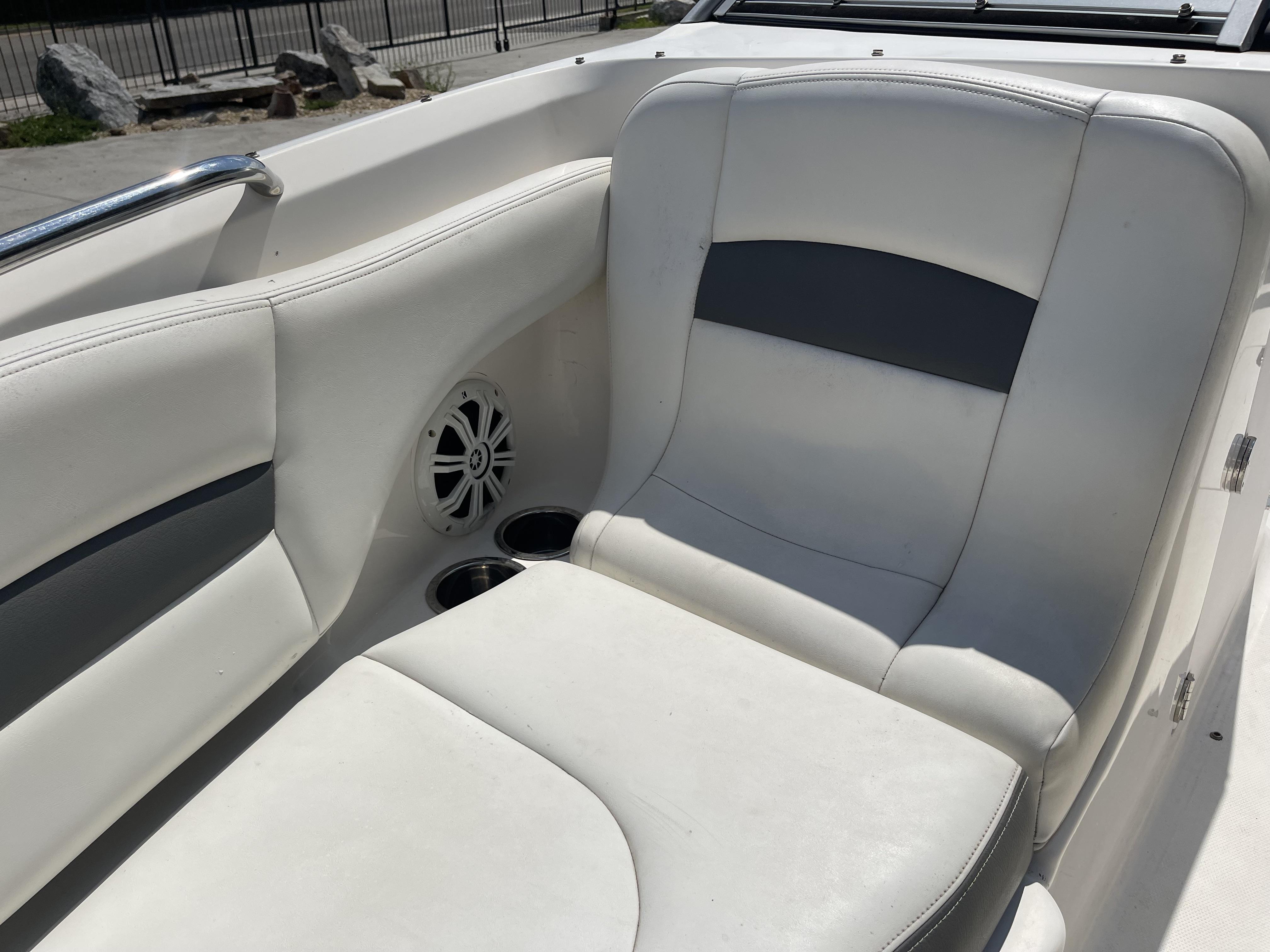 2014 Chaparral Sunesta 224 boat interior with white seating and speaker.