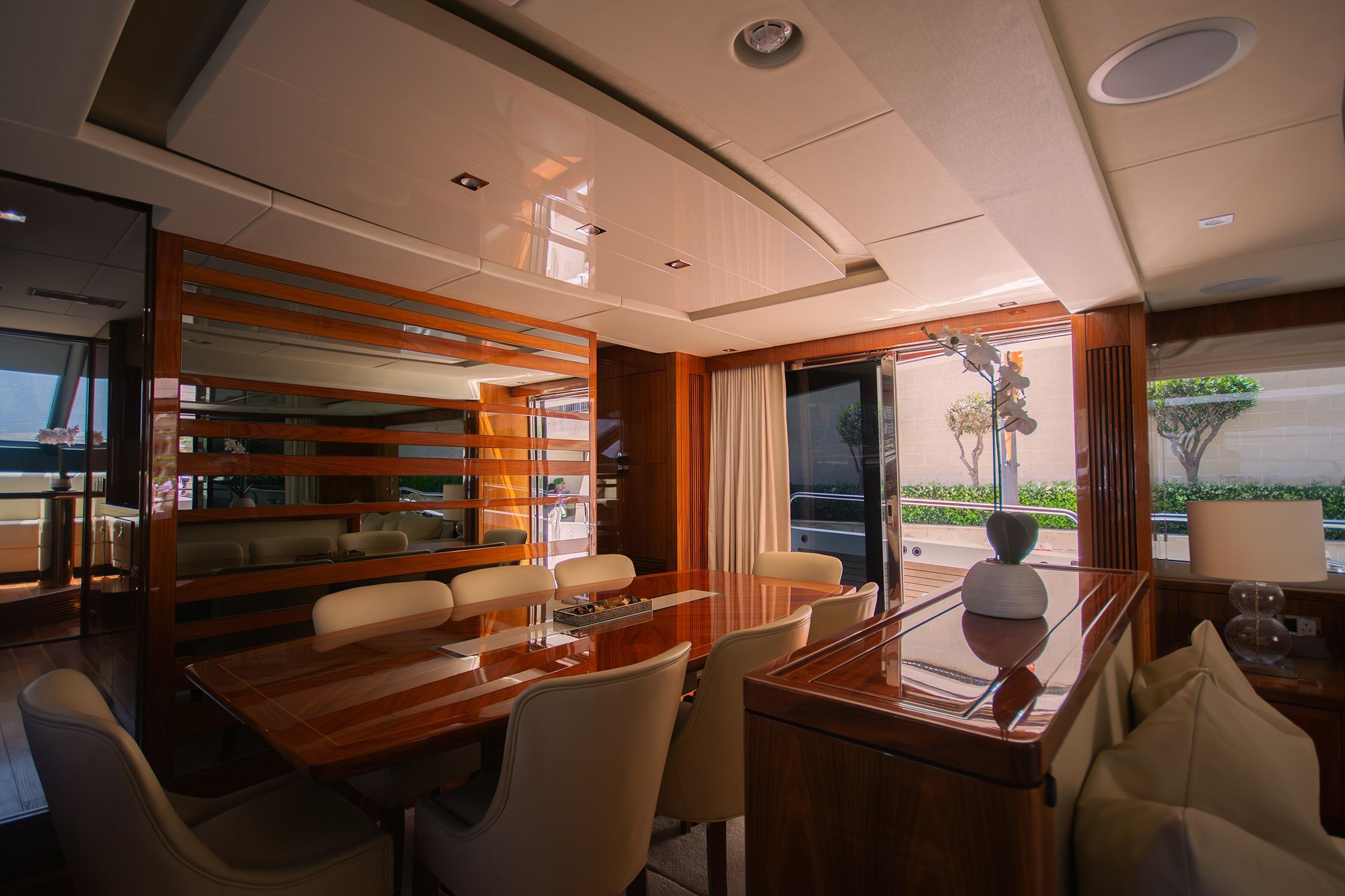 Luxurious interior of 2016 Sunseeker 86 Yacht with elegant dining area and modern decor.