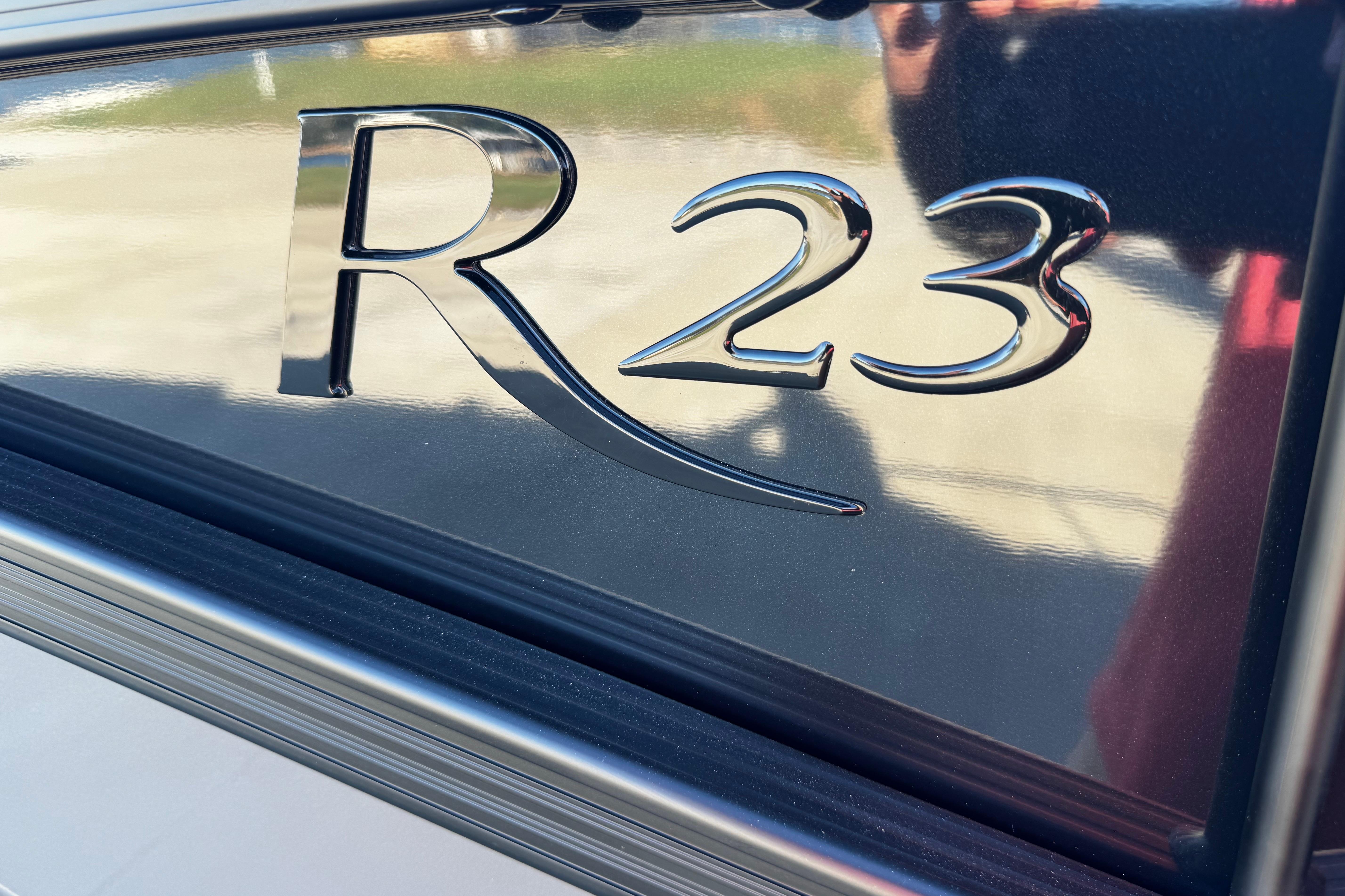 Close-up of 2025 Bennington 23RSB model emblem on a sleek surface.
