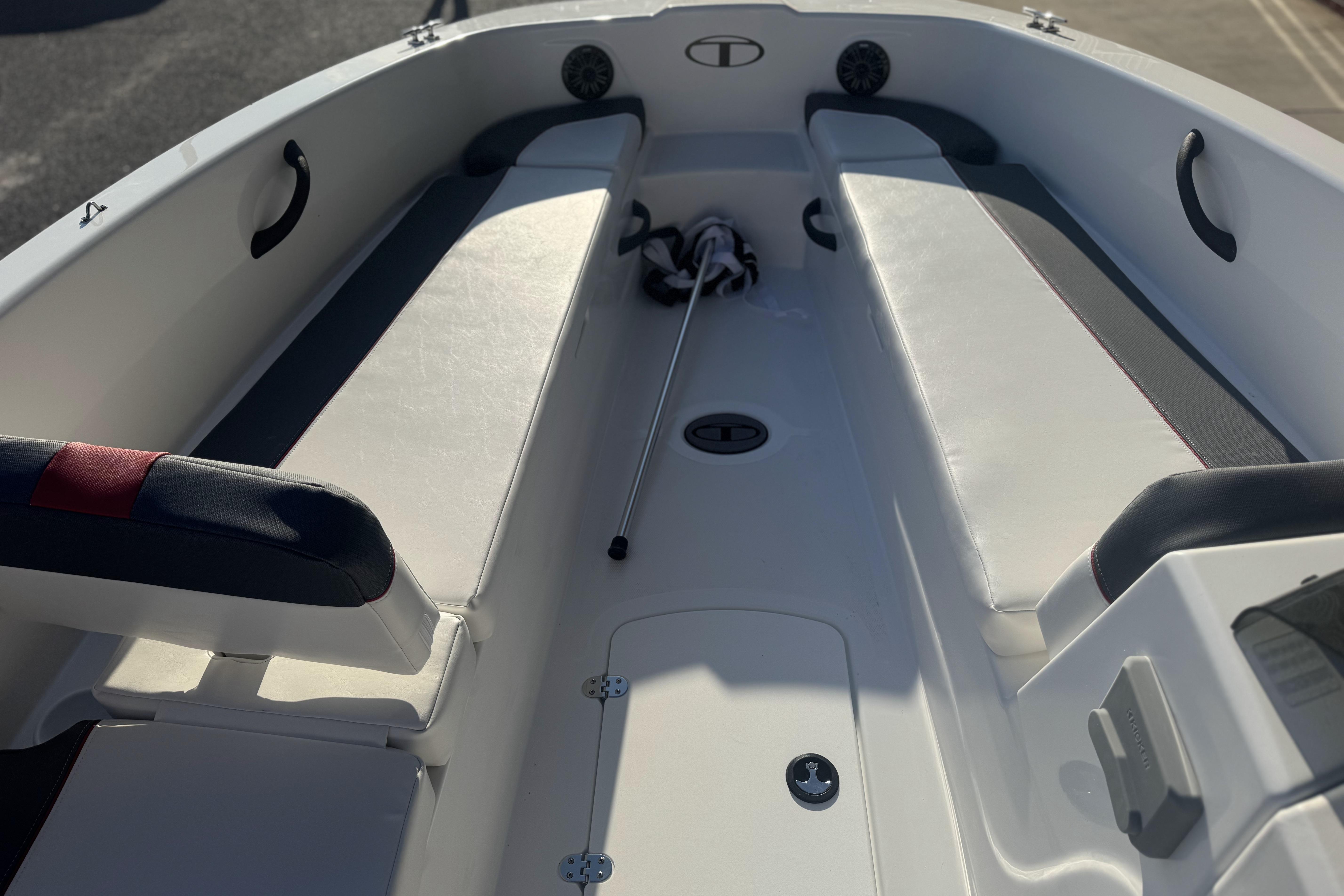 Interior view of 2026 Tahoe T18 boat, featuring seating and storage compartments.