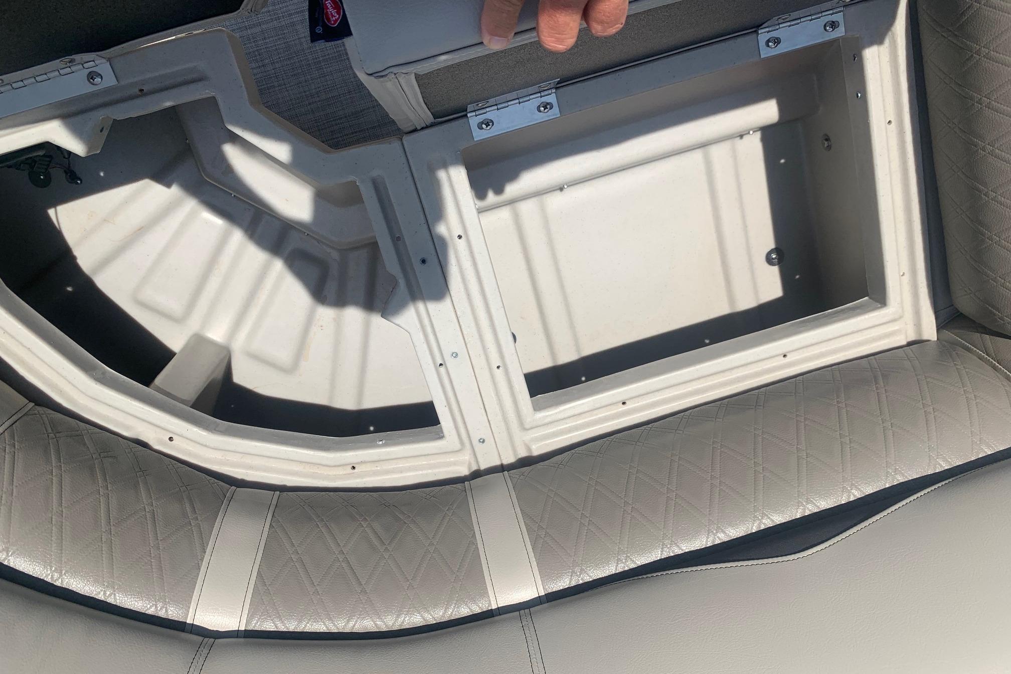 Storage compartment in 2023 Silver Wave 2410 SW3 CLS boat with cushioned seating.