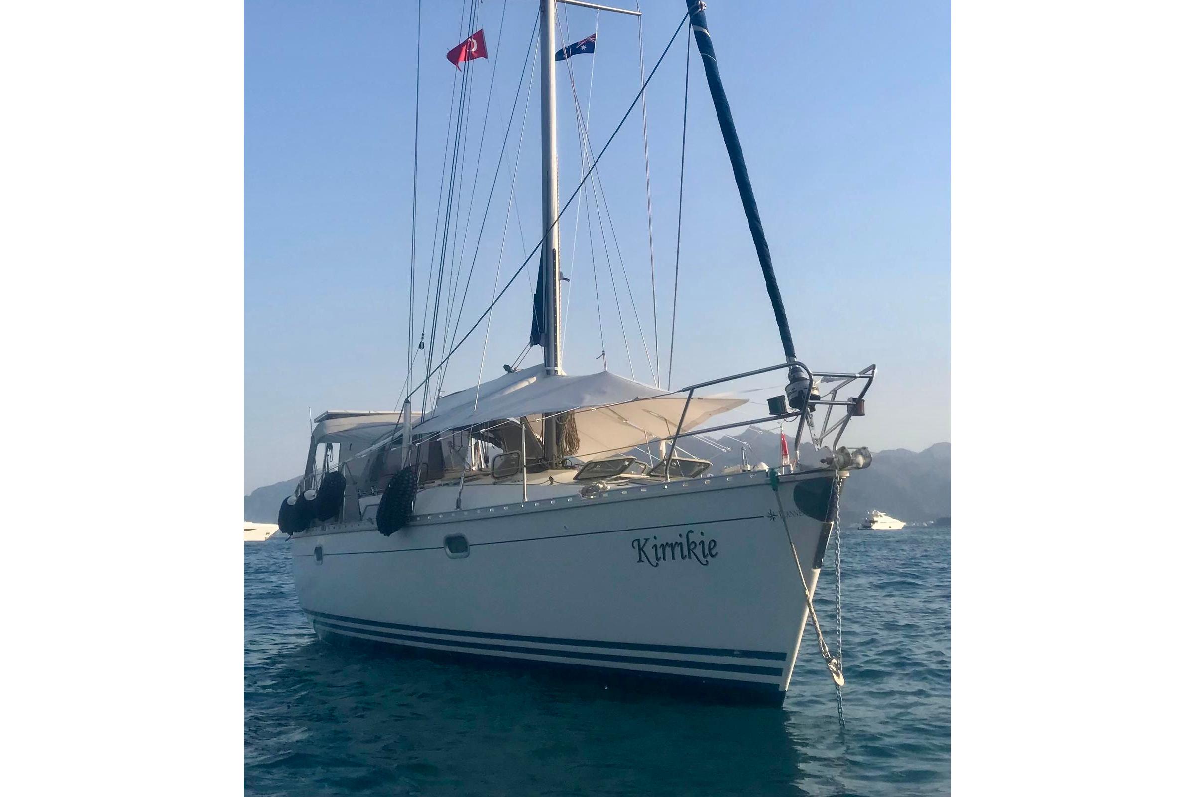 Jeanneau Sun Odyssey 45.1 sailboat from 1995 anchored in calm waters.