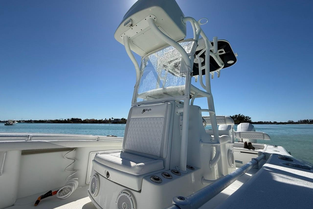 2017 Yellowfin 26 Hybrid boat on calm water, featuring sleek design and modern amenities.
