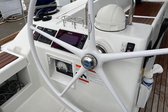 Steering wheel and controls of a 2018 Beneteau Oceanis 45 sailboat.
