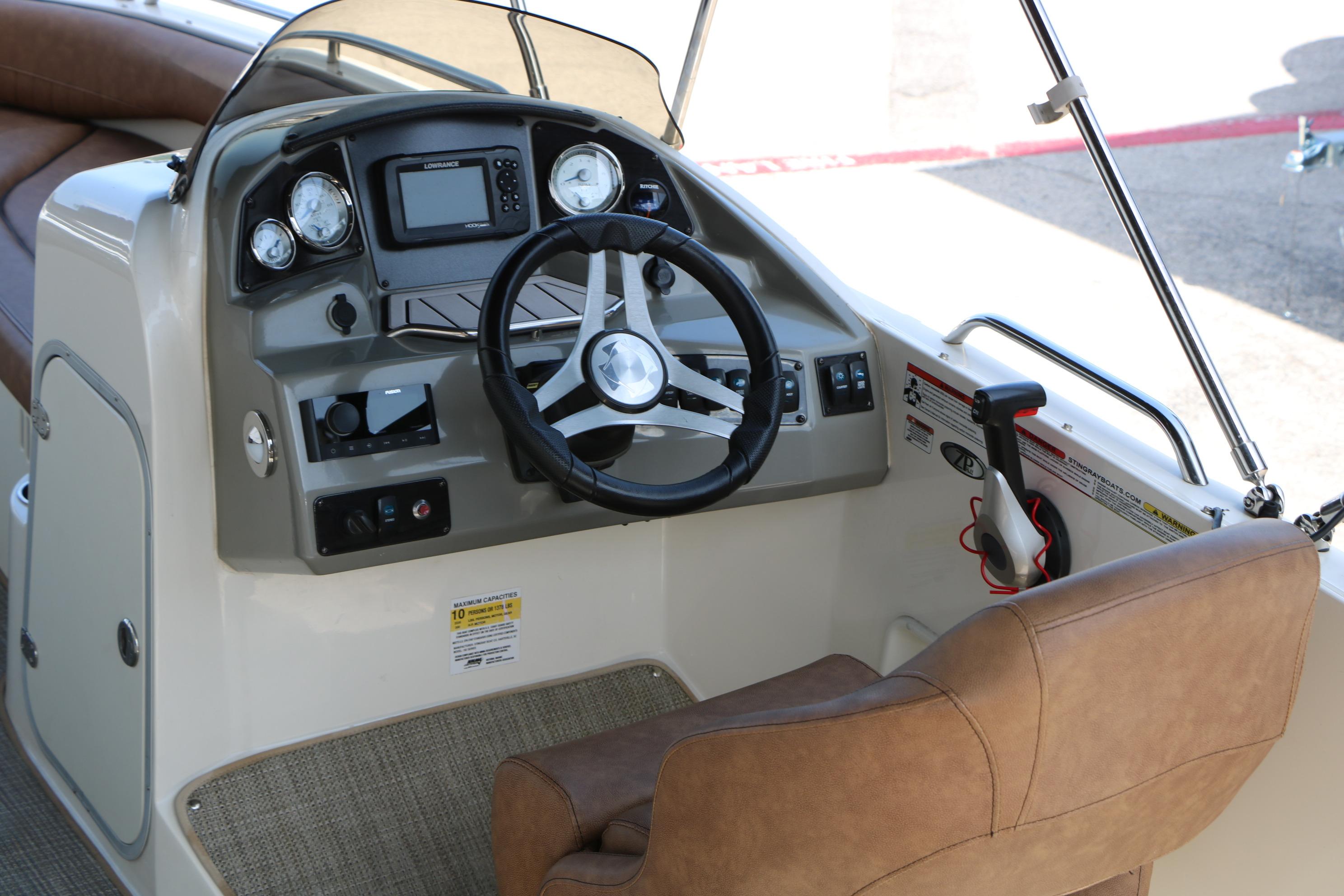 2022 Stingray 192 SC boat dashboard with steering wheel and control panel.