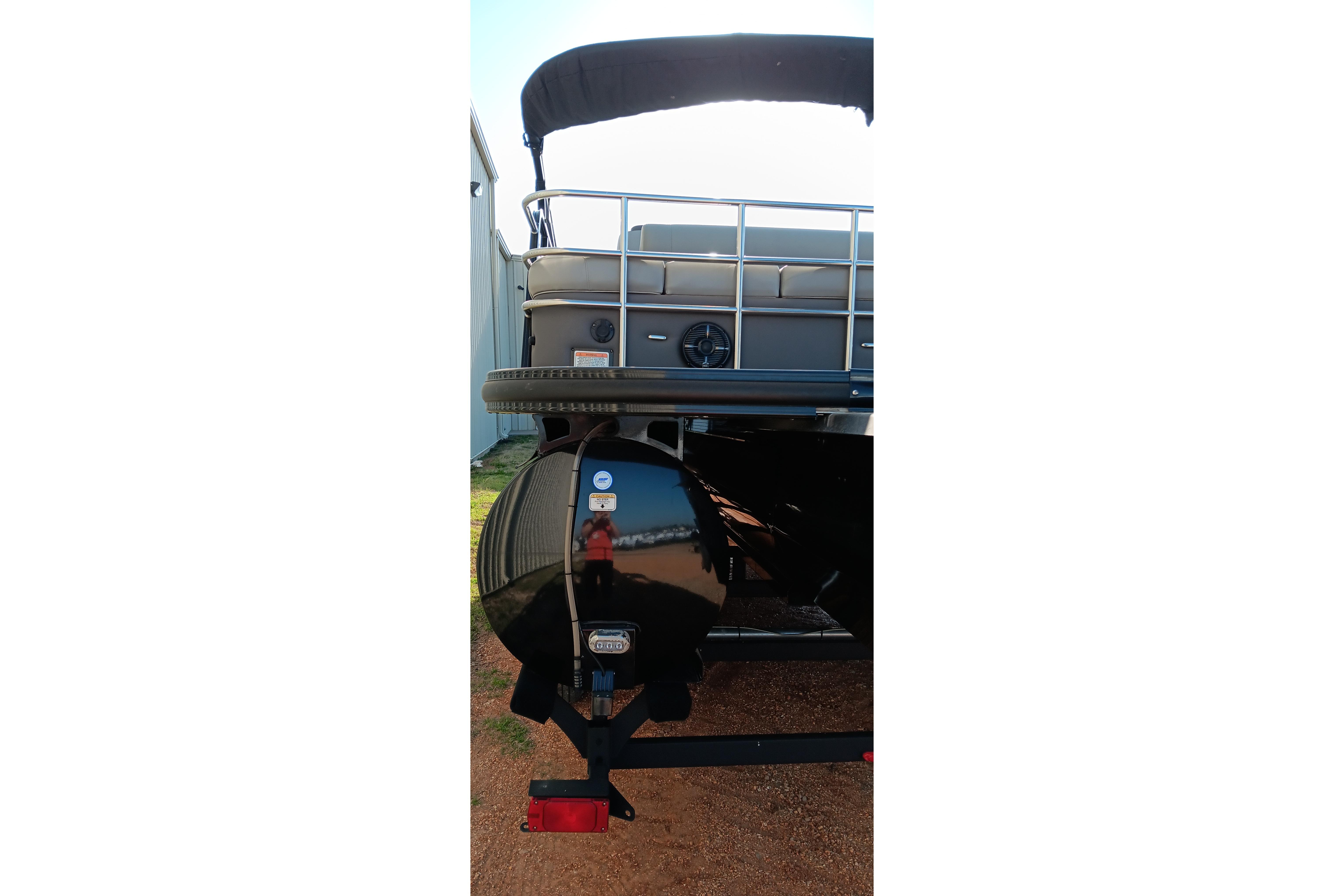 Rear view of 2023 Ranger 2500LS pontoon boat with canopy and trailer.