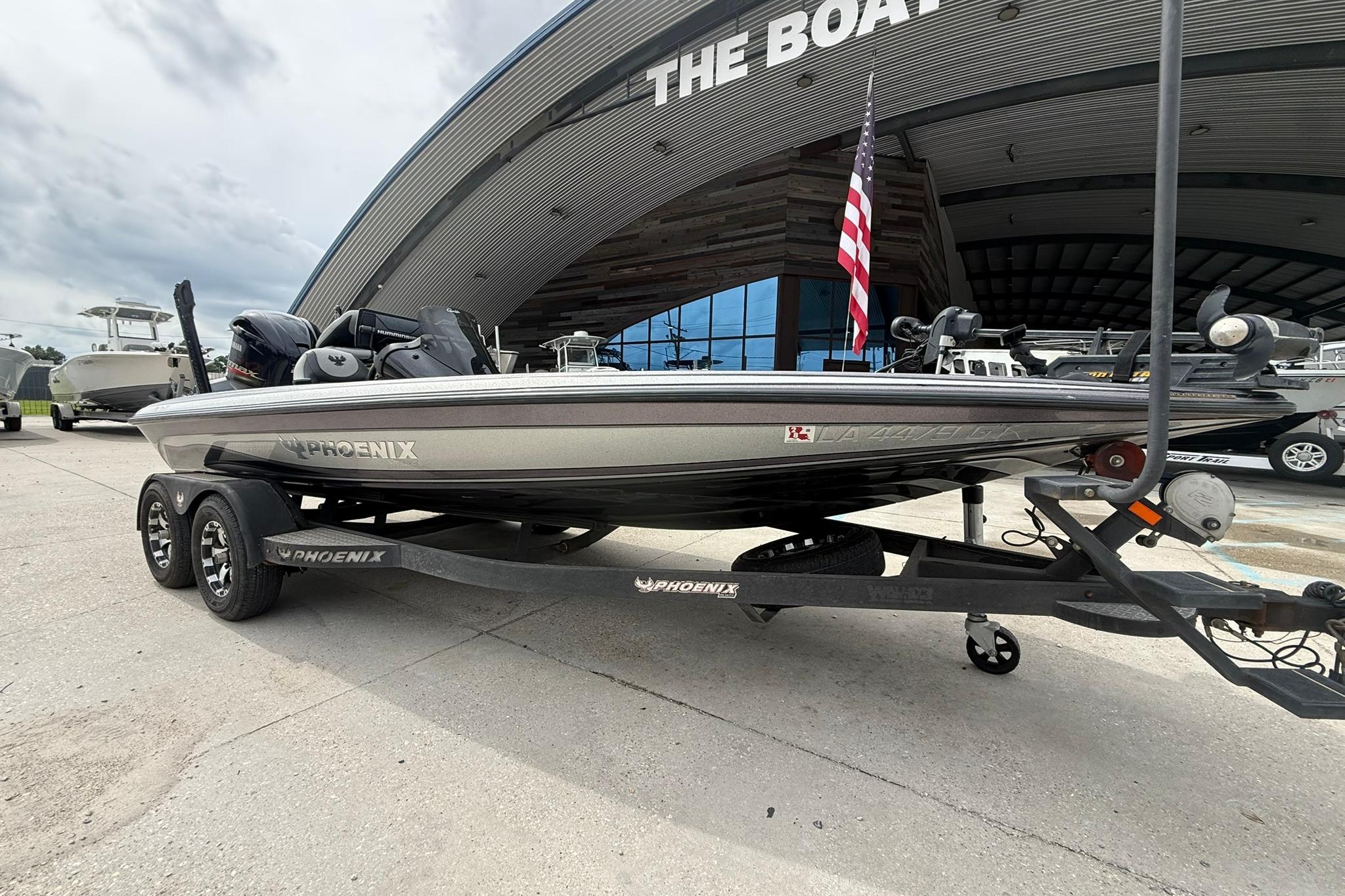 2018 Phoenix 919 ProXP boat on trailer outside dealership, American flag visible.