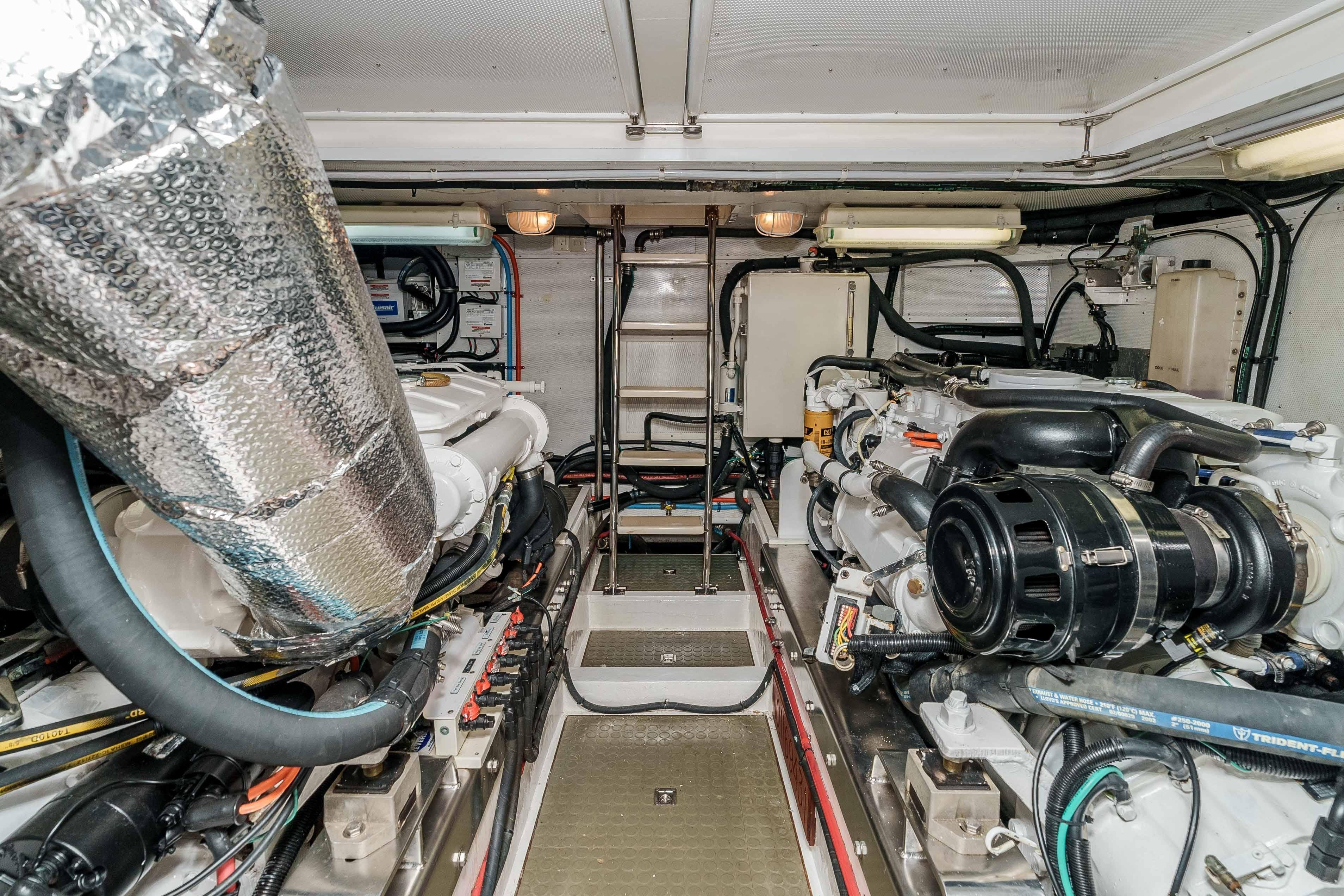 Engine room of 2005 Offshore Yachts 54 Pilothouse, showcasing dual engines and mechanical systems.