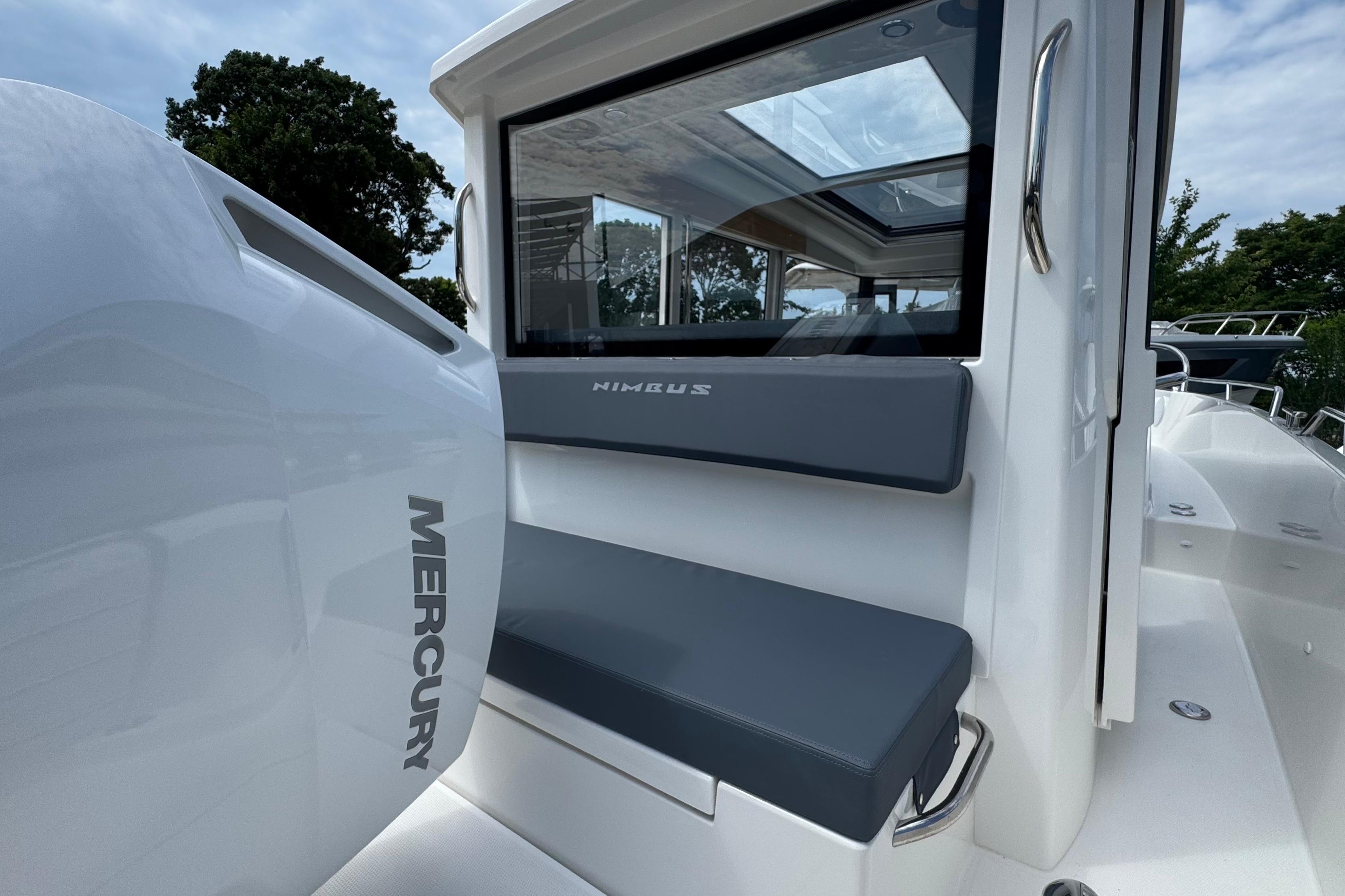The image shows the stern of a Nimbus Commuter 9 boat with a Mercury engine.
