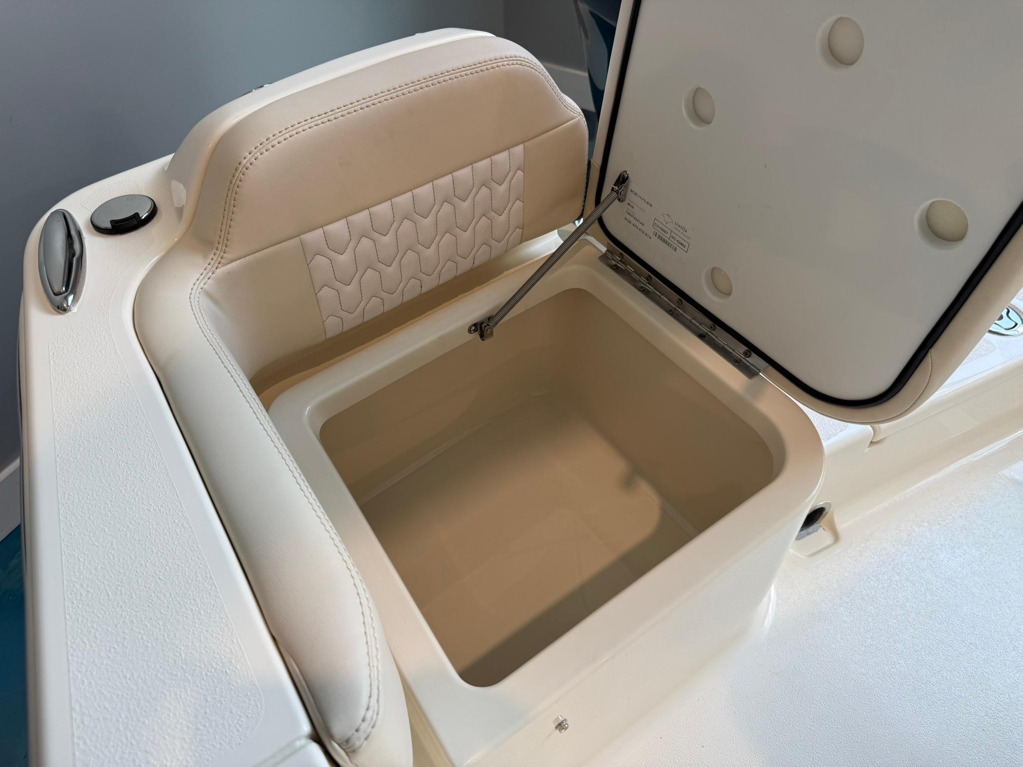 2026 Scout 188 SF boat storage compartment with open lid, featuring cushioned seating.