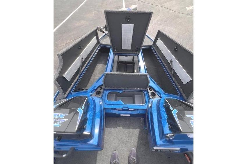 2026 Nitro Z19 XL boat with open storage compartments in a parking lot.