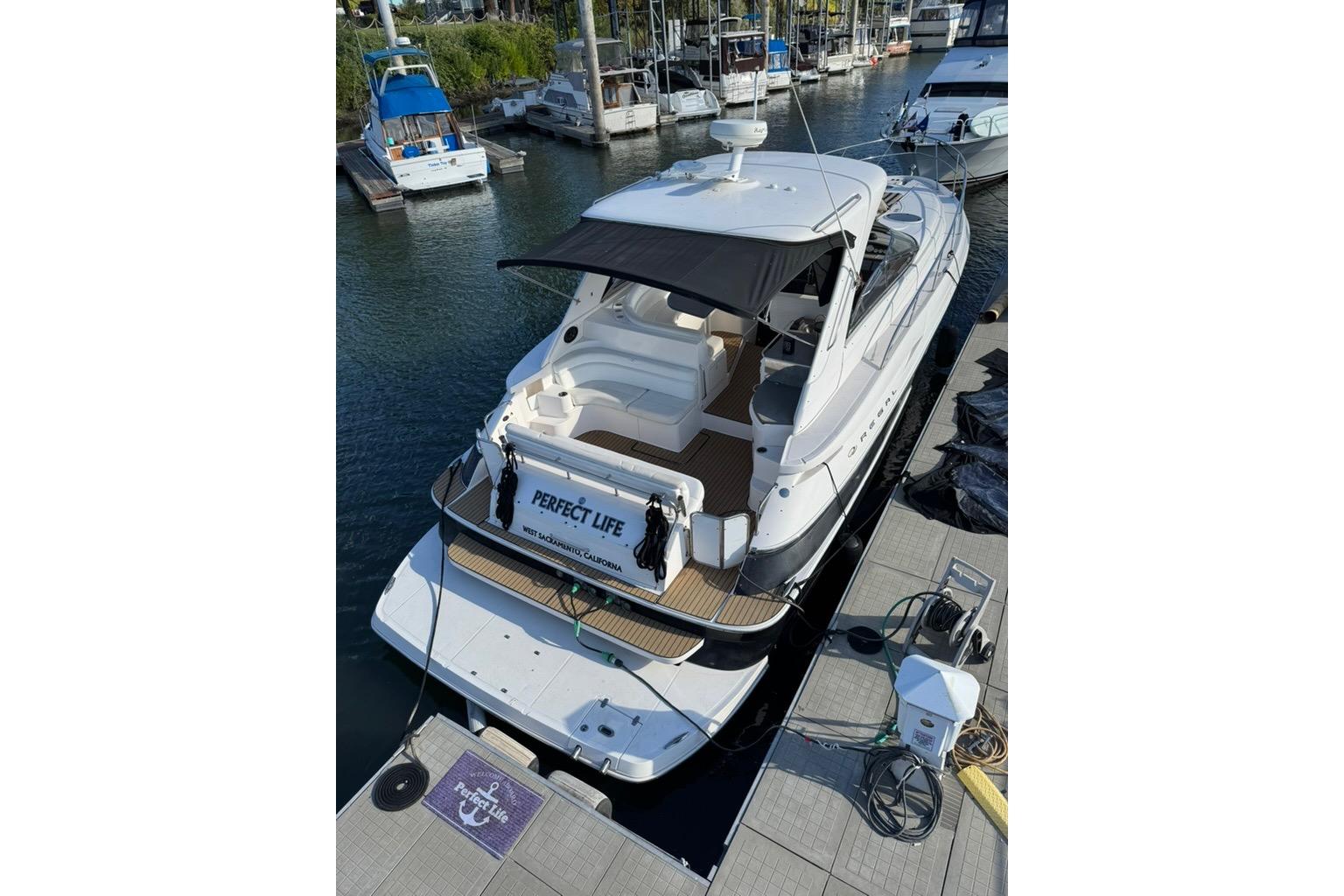 2006 Regal Commodore 4460 yacht docked at marina, rear view.