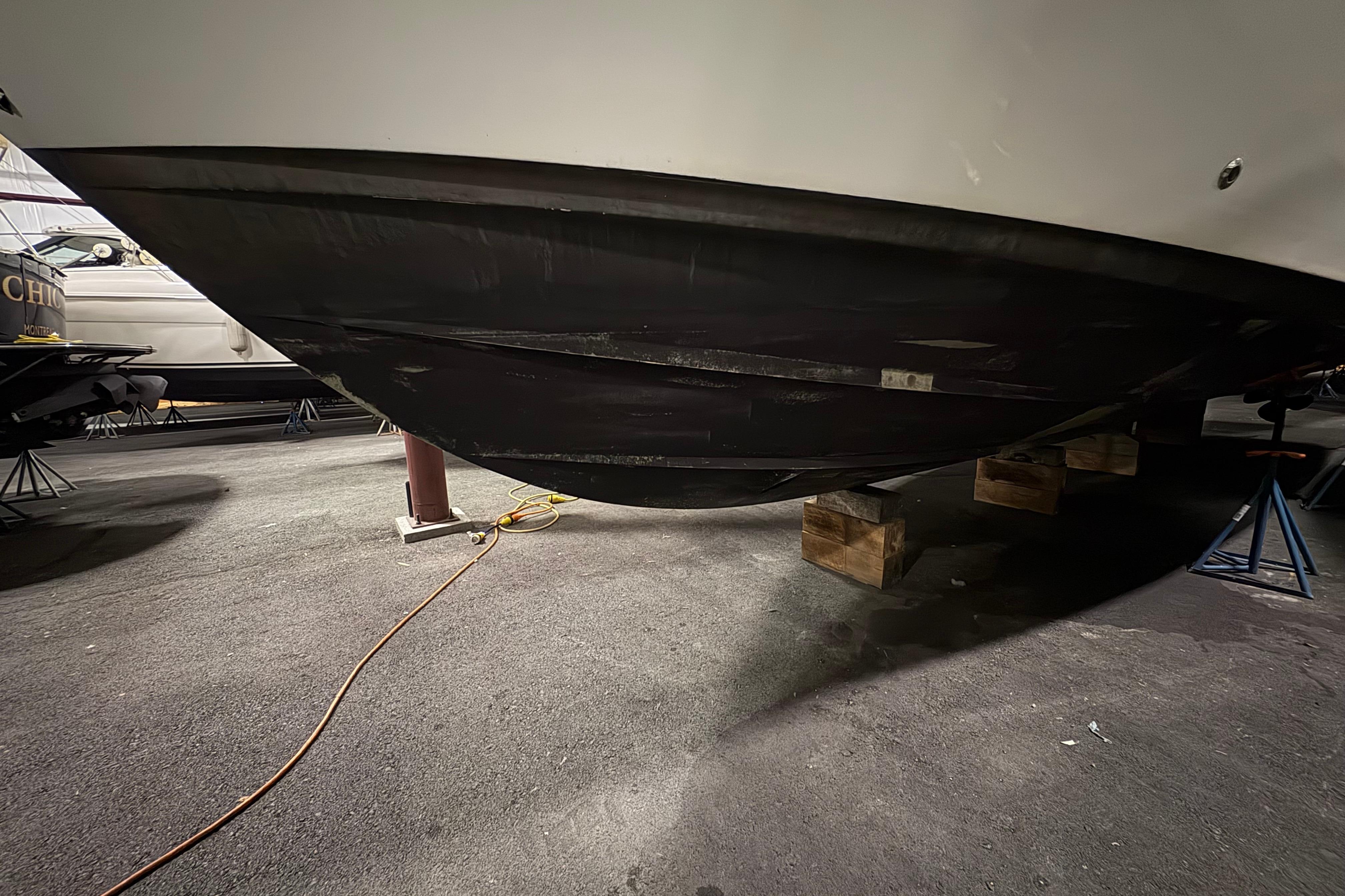 2003 Silverton 43 Motor Yacht hull on blocks in storage facility.