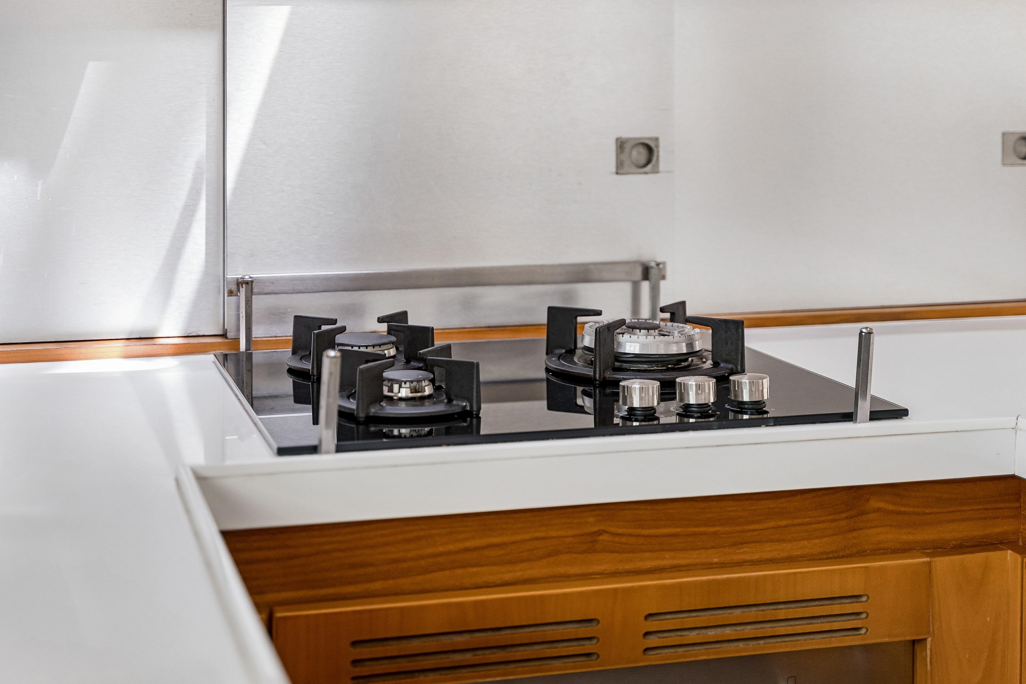 Modern kitchen stove on Catana 65 yacht, 2009 model, featuring sleek design and functionality.