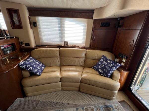 Luxurious leather sofa in 2009 Ovation 52 yacht interior with nautical-themed pillows.