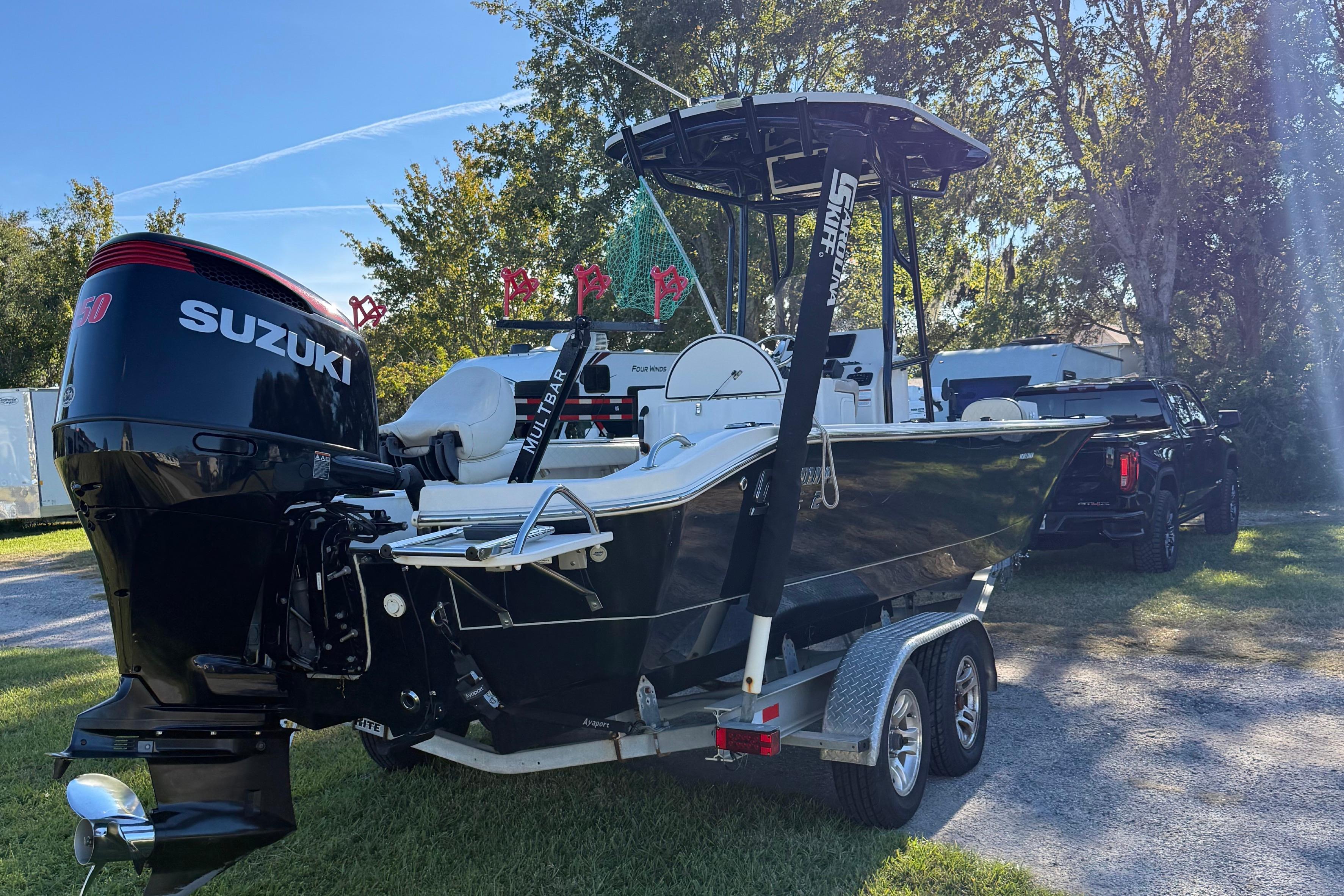 2021 Carolina Skiff 26 Ultra Elite boat with Suzuki engine on trailer.