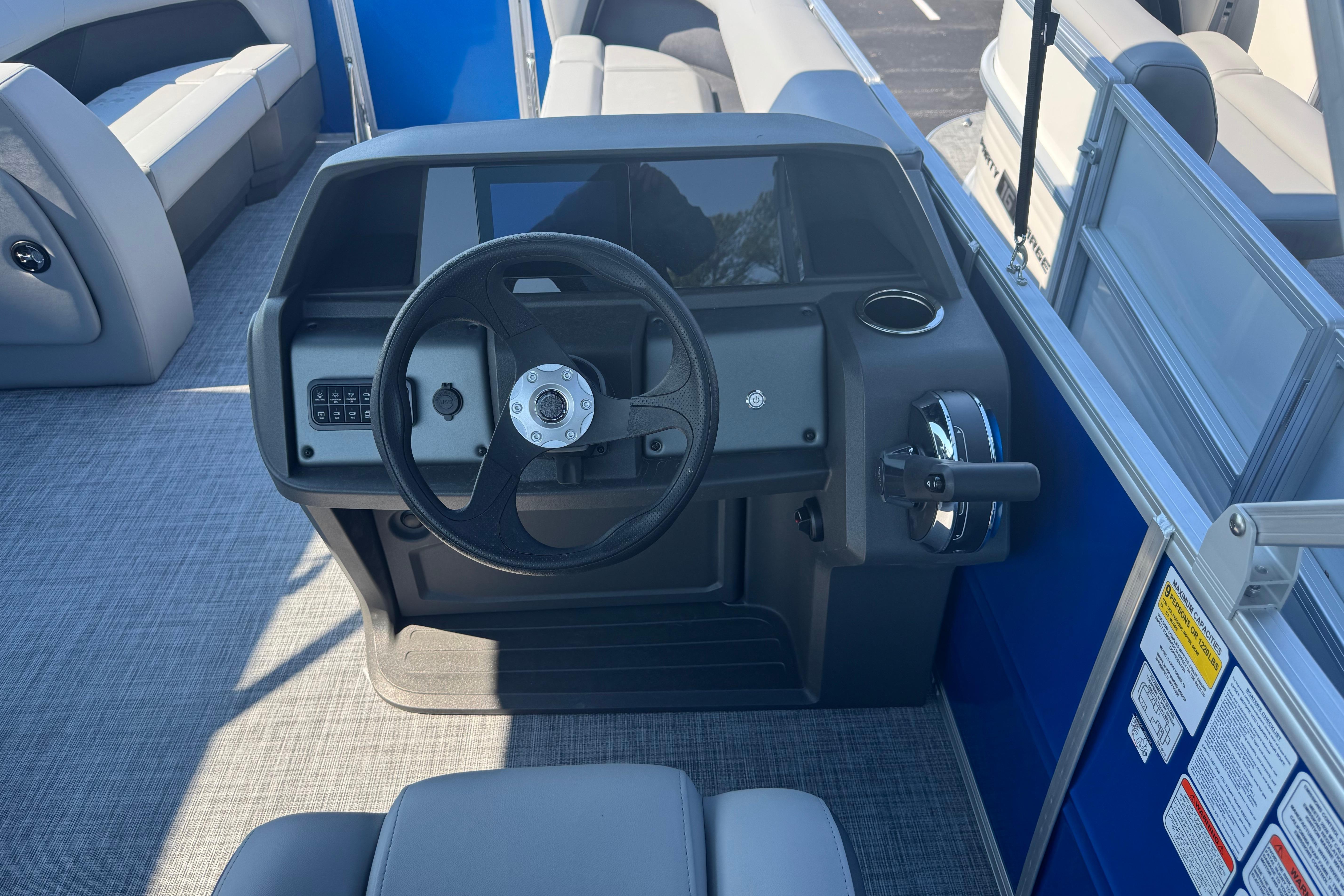 2026 Sun Tracker Party Barge 18 DLX steering console with modern controls and seating.