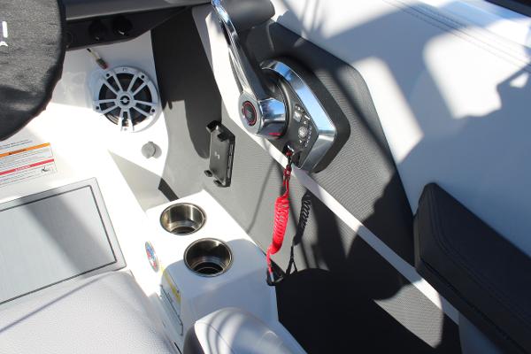 2025 Cobalt CS23 boat interior with control panel and cup holders.