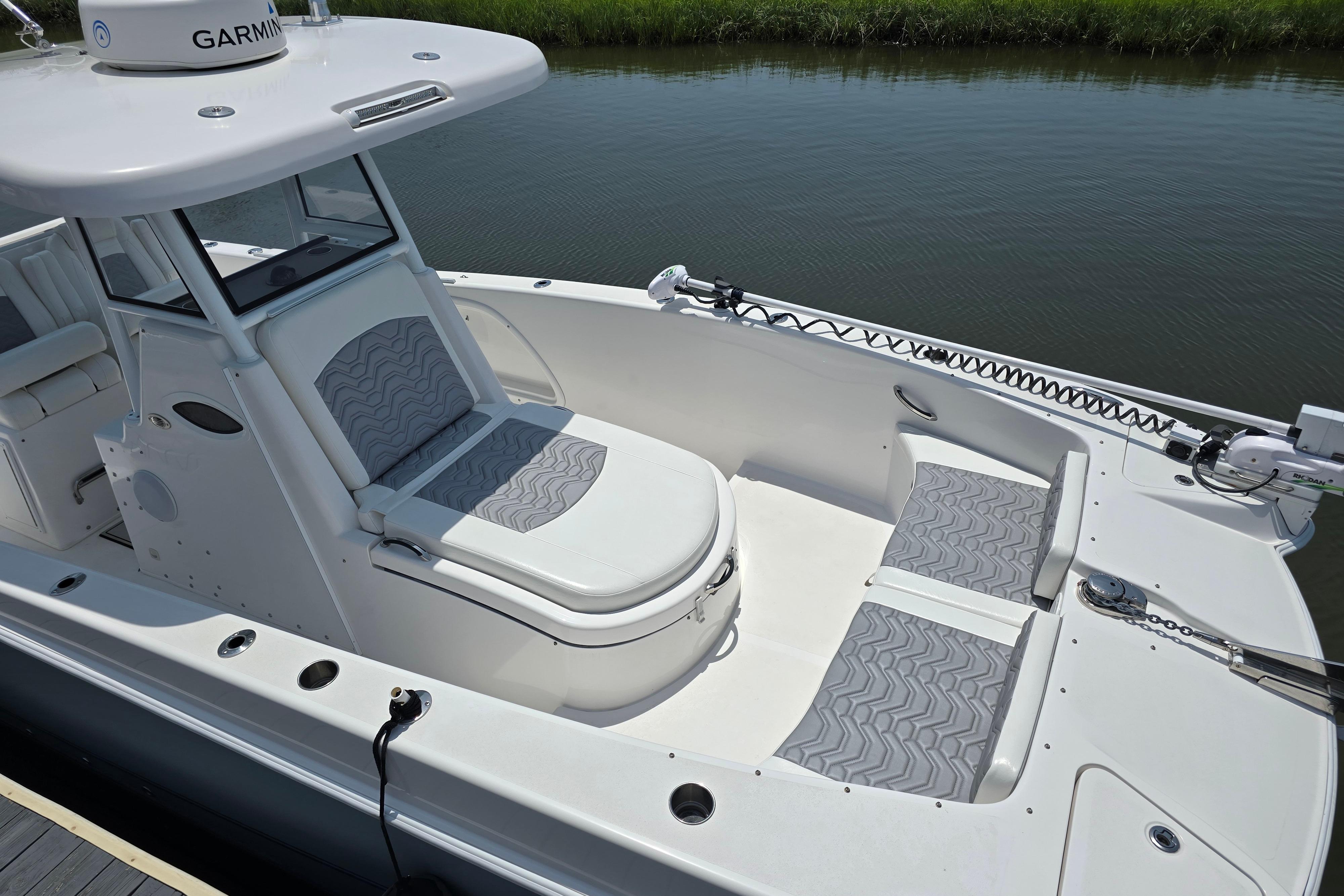 2021 Twin Vee 280 GFX CC boat with cushioned seating, docked on calm water.