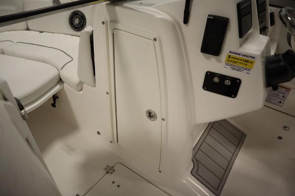 Interior view of 2025 Sea Fox 228 Traveler boat, featuring seating and control panel.