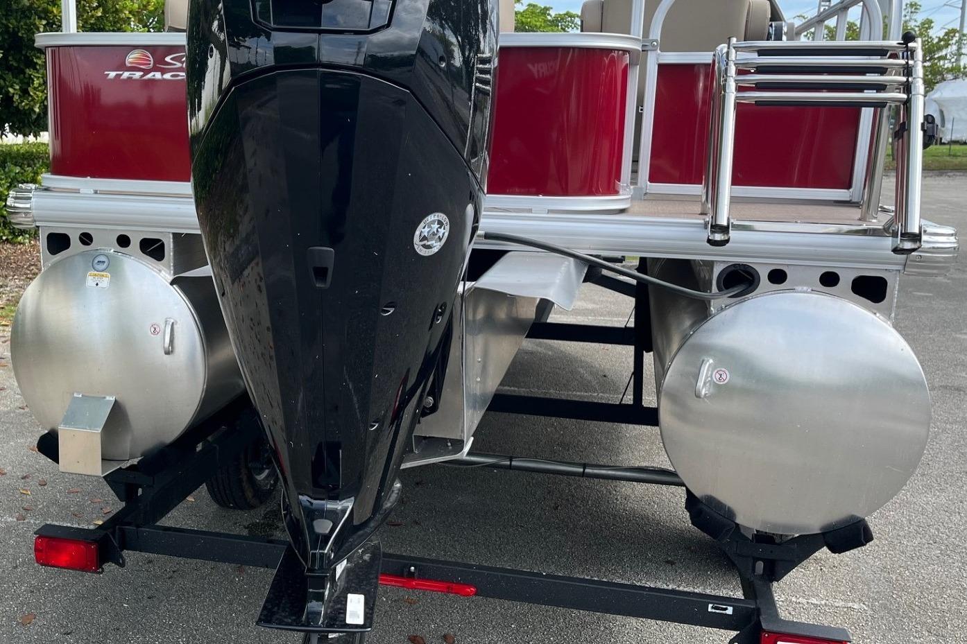 2025 Sun Tracker Party Barge 18 DLX pontoon boat rear view with motor and pontoons.