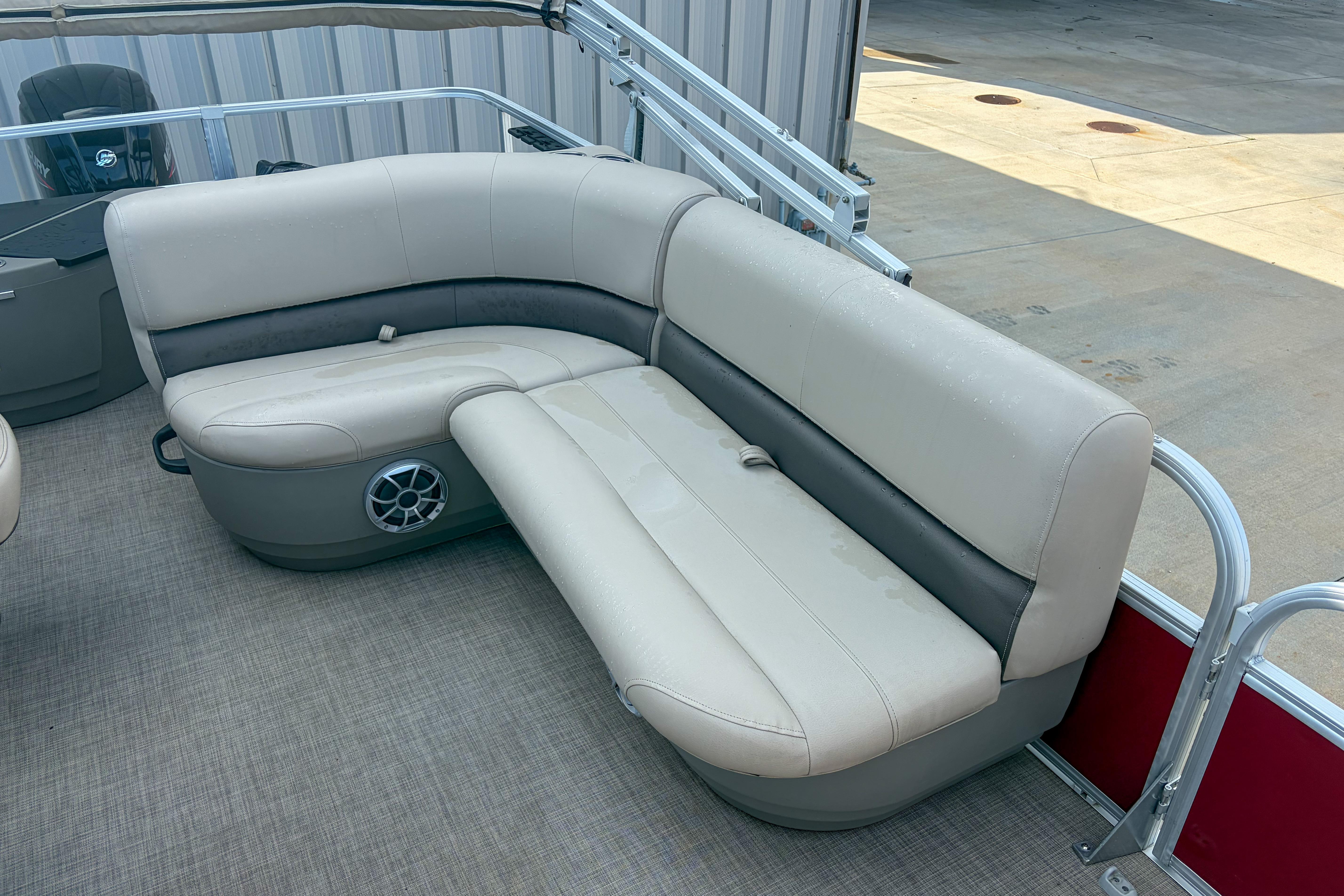 2024 Sun Tracker Bass Buggy 18 DLX pontoon boat with beige seating and speaker.
