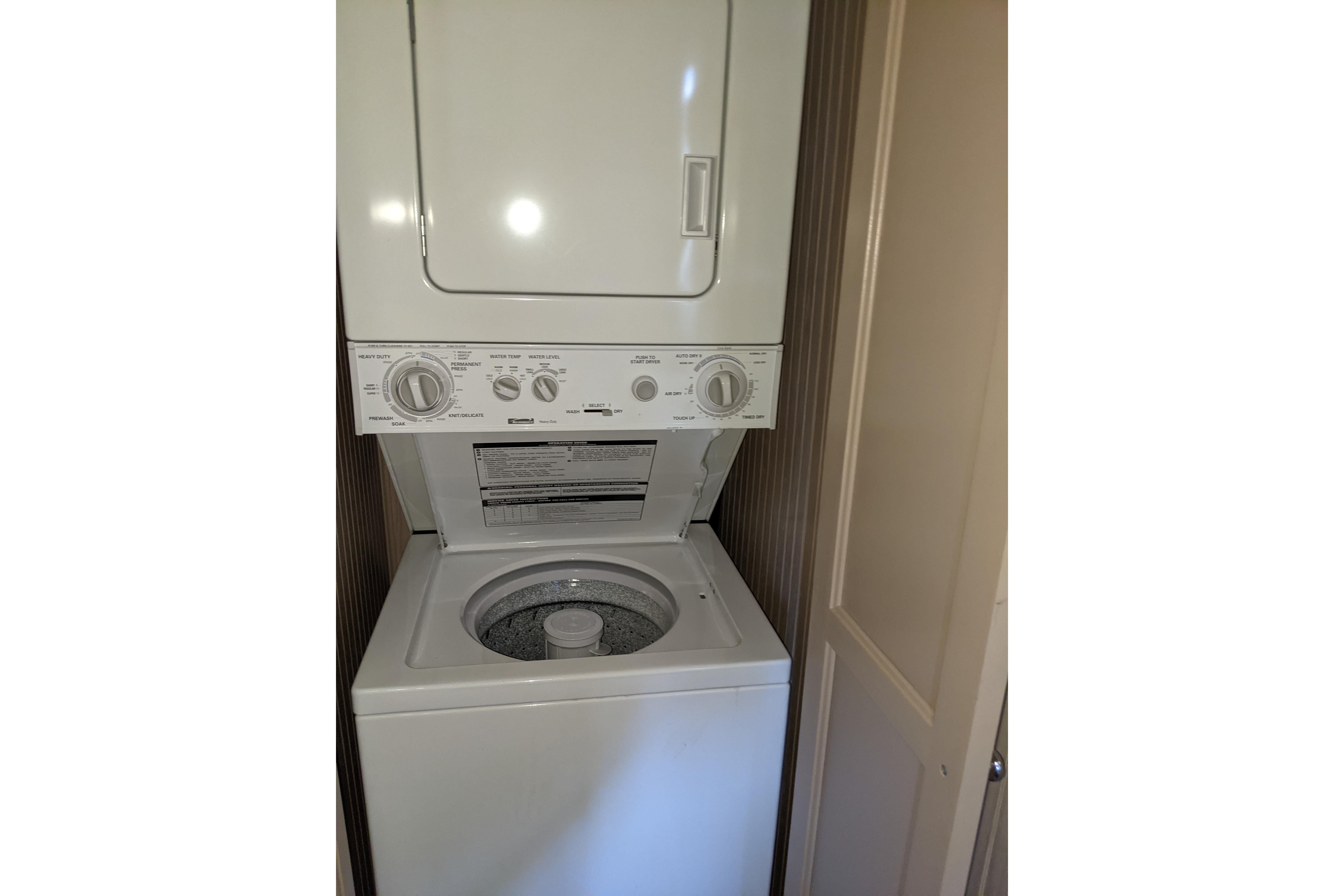 Stacked washer and dryer unit inside a 2001 Gibson 50 Cabin Yacht.