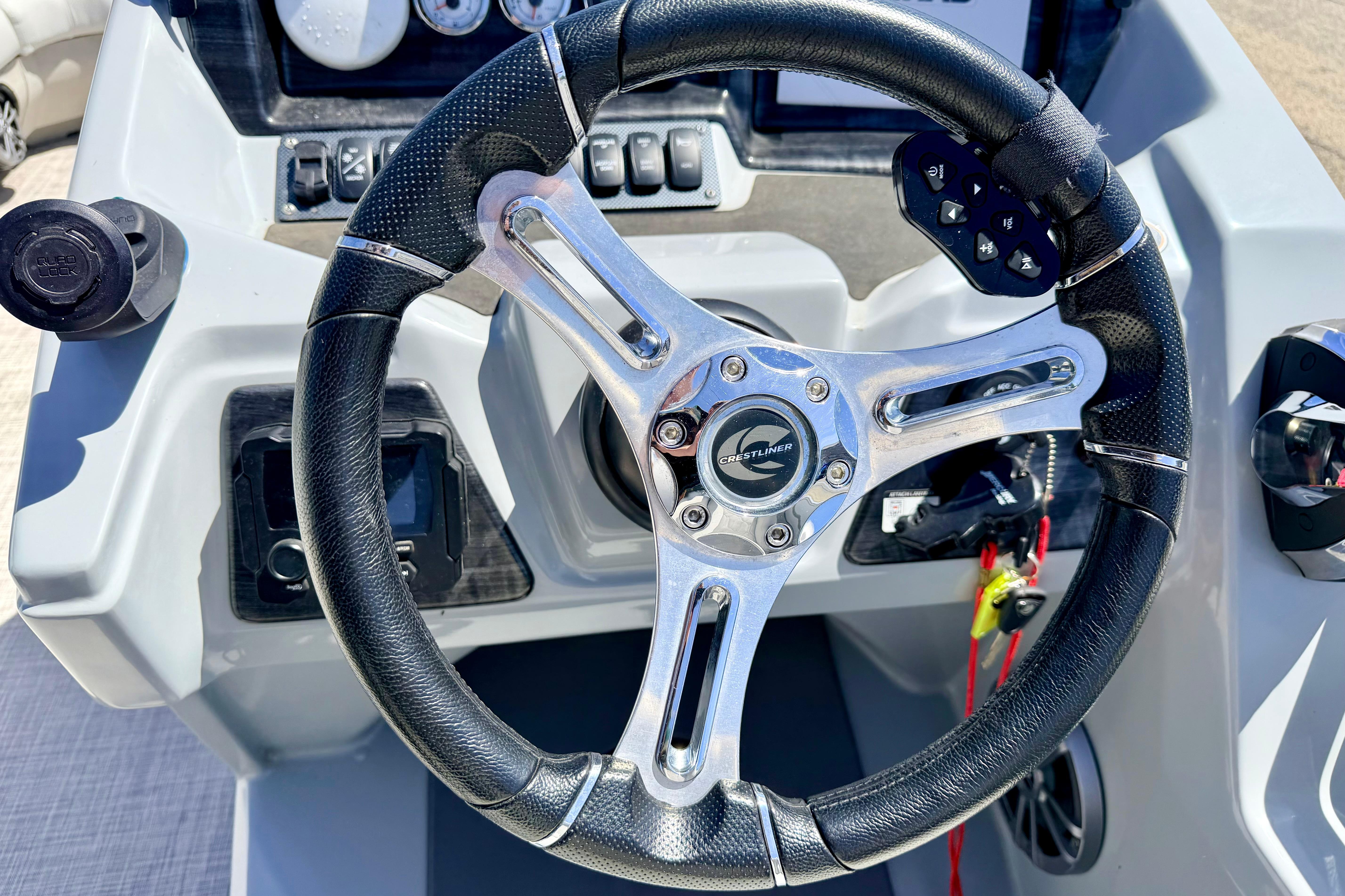 Steering wheel of 2019 Crestliner 240 Rally DX CW boat, featuring sleek design and controls.