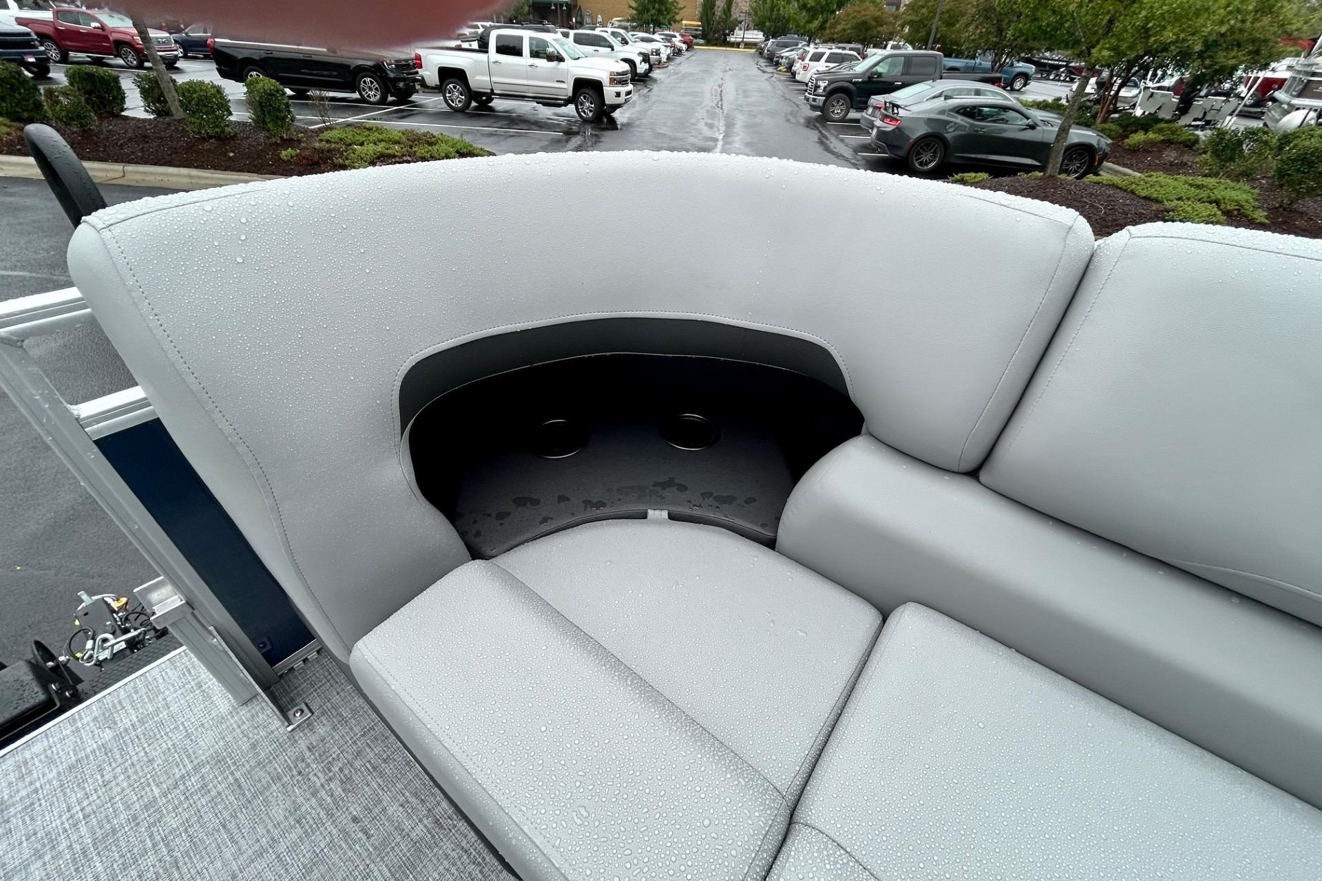 2026 Sun Tracker SportFish 22 DLX boat interior with wet gray seating and cup holders.
