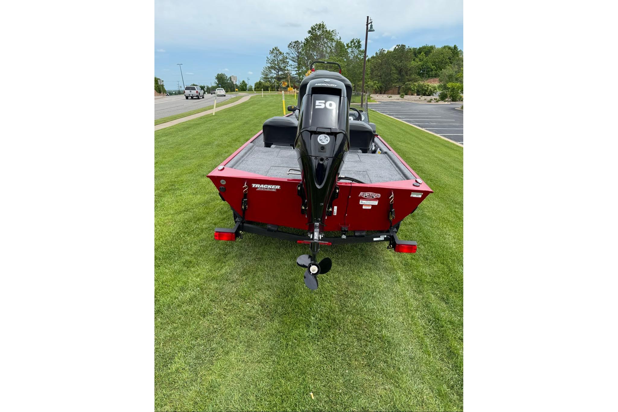 2026 Tracker Bass Tracker Classic XL boat with 50 HP motor on grass.