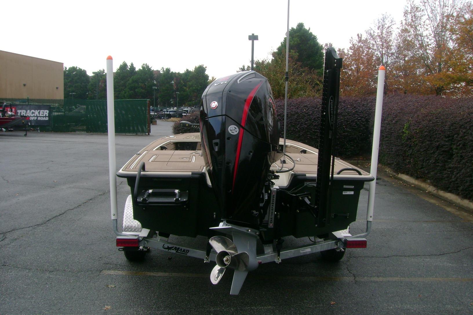 2025 Mako 18 Pro Skiff Backwater Edition on trailer, rear view in parking lot.