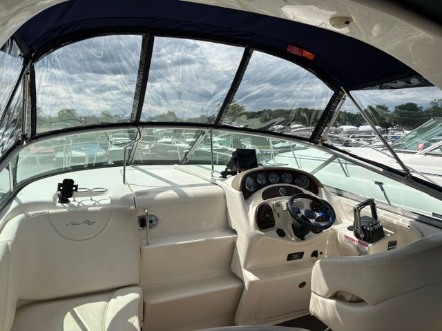 The cockpit of a 2005 Sea Ray Sundancer 280 with clear windows and a modern helm.