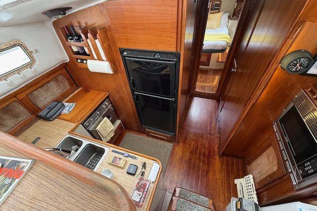 Interior of 1982 Lancer 45 Motorsailer with wood finish, kitchen, and cozy cabin.