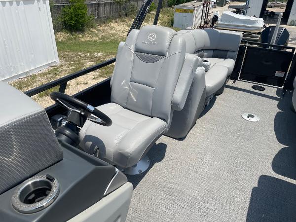 2023 Regency 250 LE3 boat interior with gray seating and steering wheel.