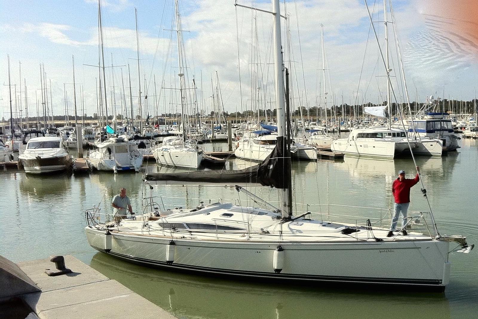 Sailboat Maxi 1300, 2010 model, docked in a marina with numerous other boats.