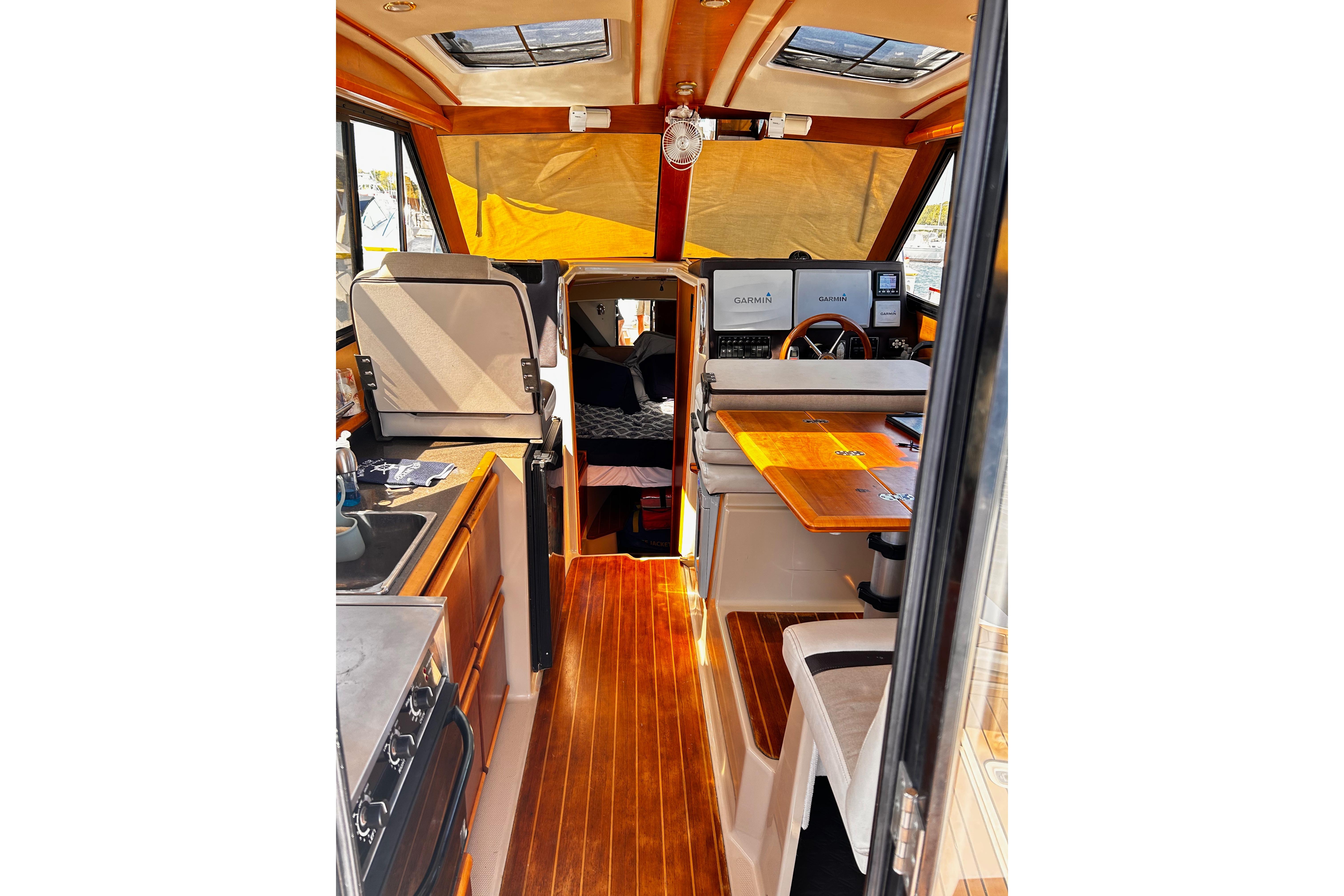Interior of 2014 Cutwater C-28 boat with wood flooring and navigation equipment.