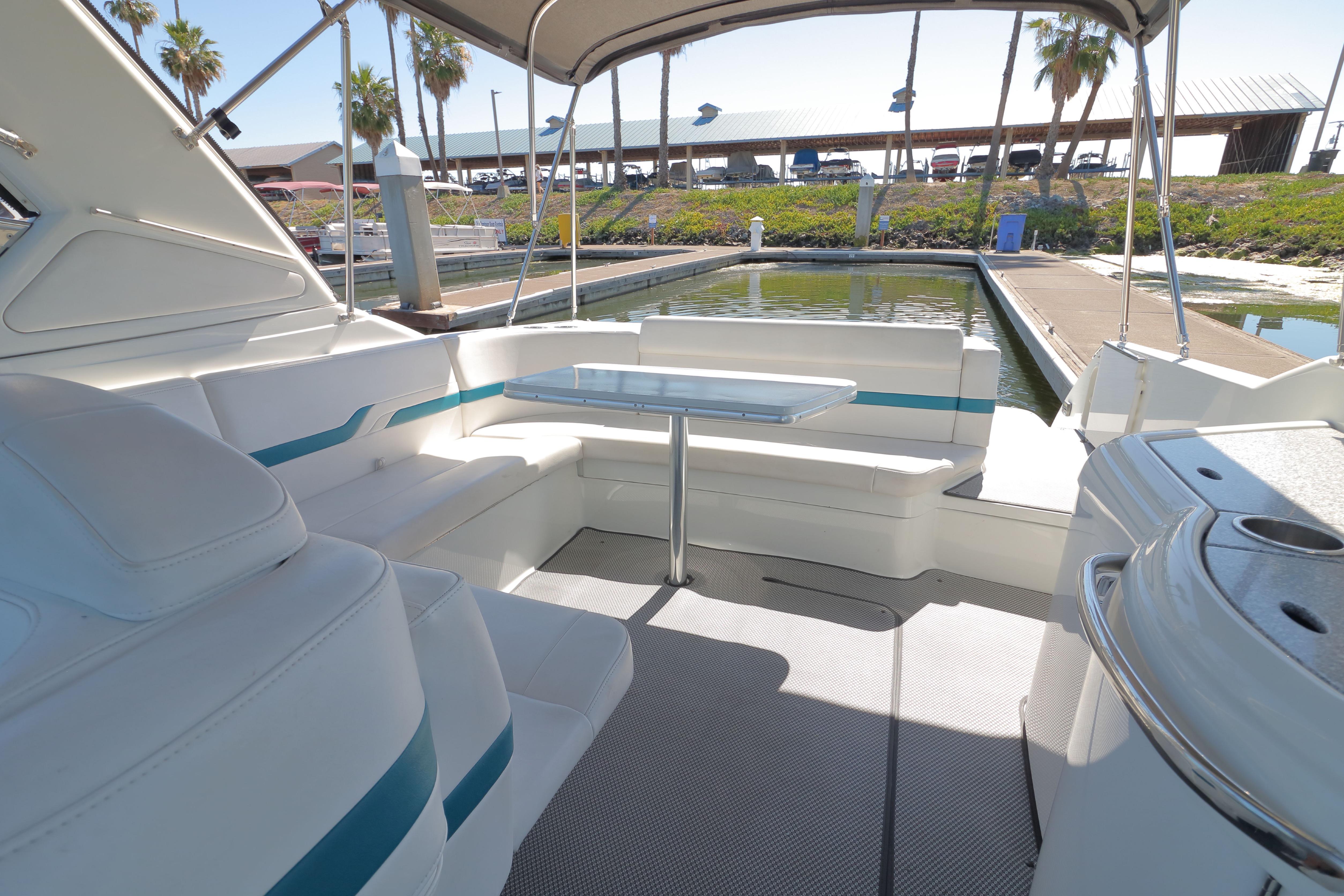 2006 Formula 330 Sun Sport boat interior with seating and table at a marina.