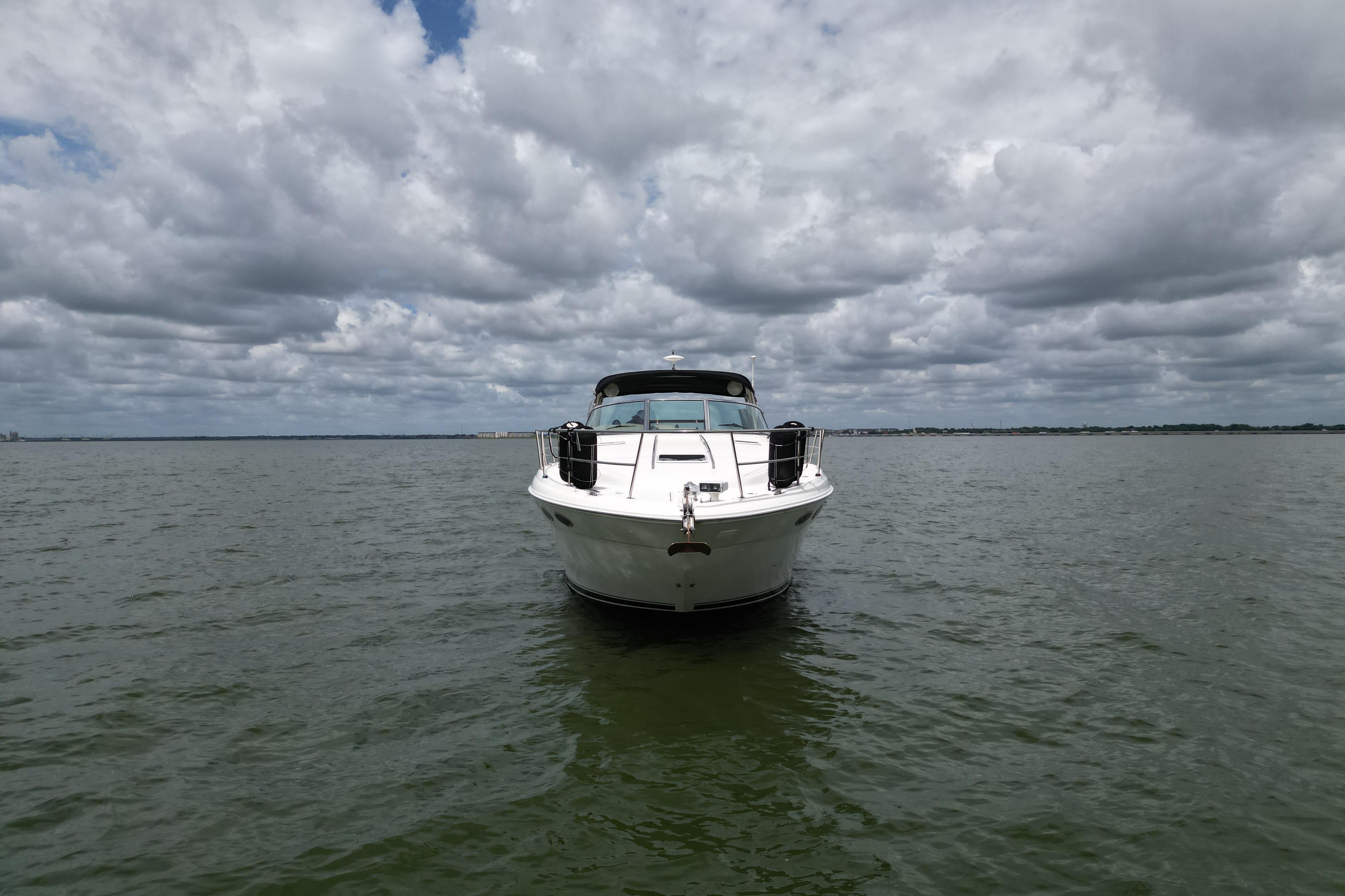 2001 Sea Ray 380 Sundancer yacht on open water under cloudy sky.